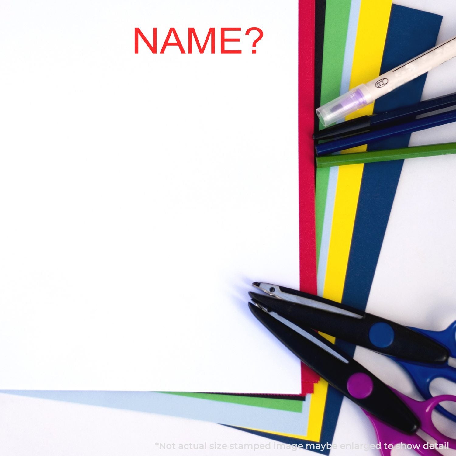 NAME? prompt beside colored paper stacks and scissors, suggesting a personalized school craft or student name activity.