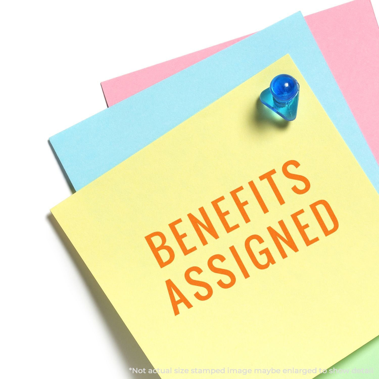 Blue pushpin pins a colorful card reading Benefits Assigned, showing workplace HR benefits assignment information.