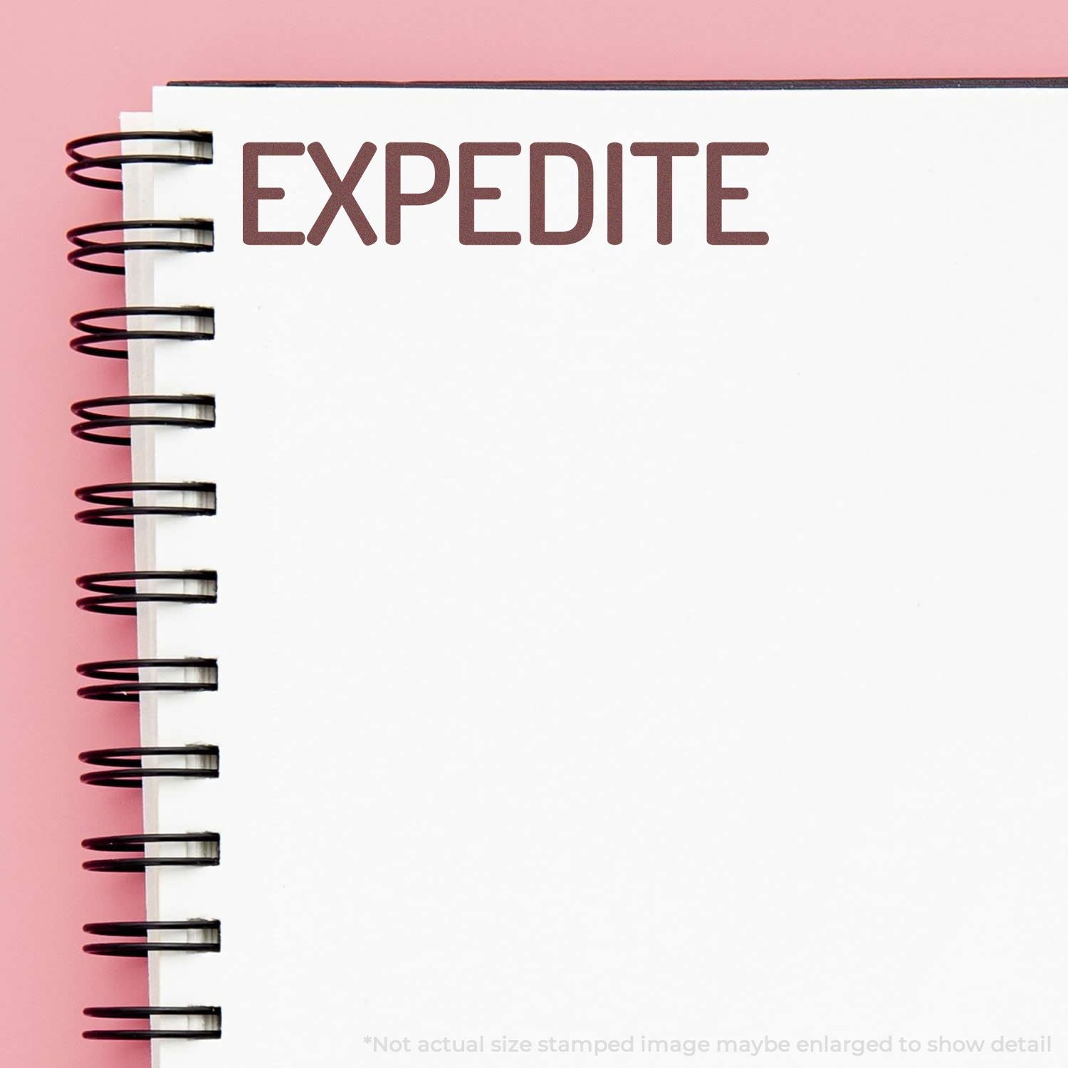 Expedite message on spiral notebook, symbolizing urgent shipping or fast processing service.
