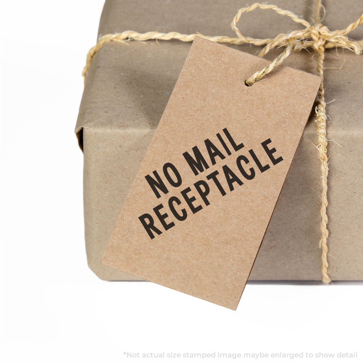 Wrapped brown parcel with twine and No Mail Receptacle tag, isolated on white background.