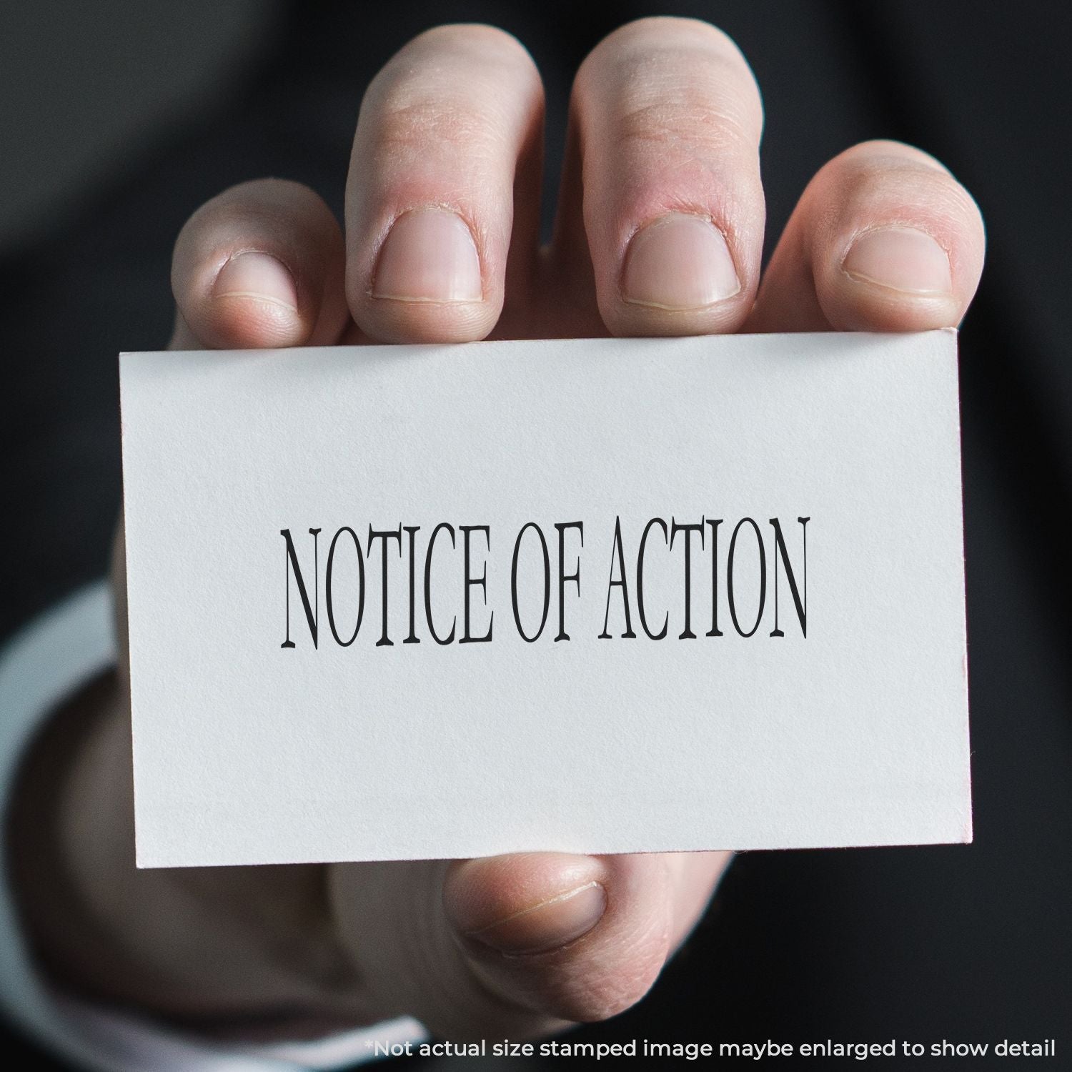 Close-up of a hand holding a Notice of Action legal document card.