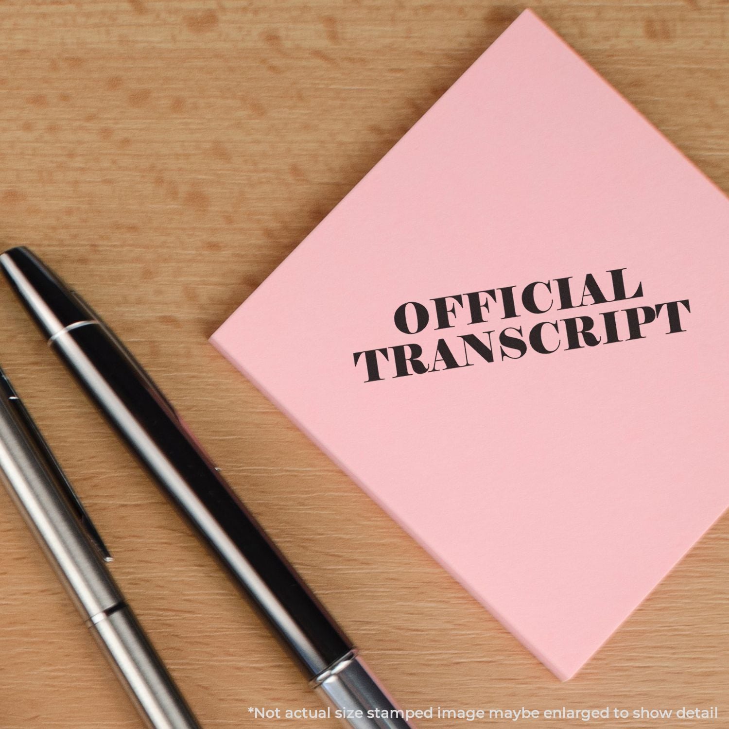 Official transcript booklet on wooden desk with penseducation records document for school transcripts and academic documentation.