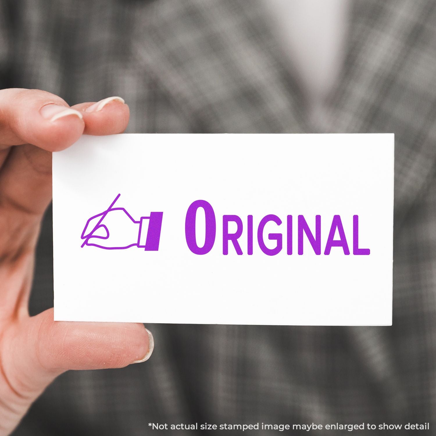 Hand holding a white card with purple Original logo and writing pen icon, signifying authentic, custom-designed branding.