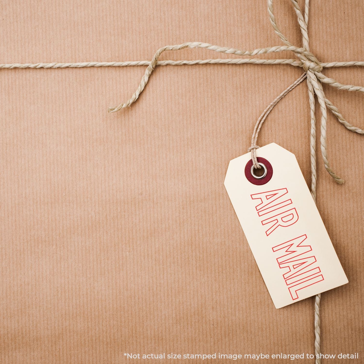 Kraft paper parcel with string and vintage air mail shipping tag on brown background