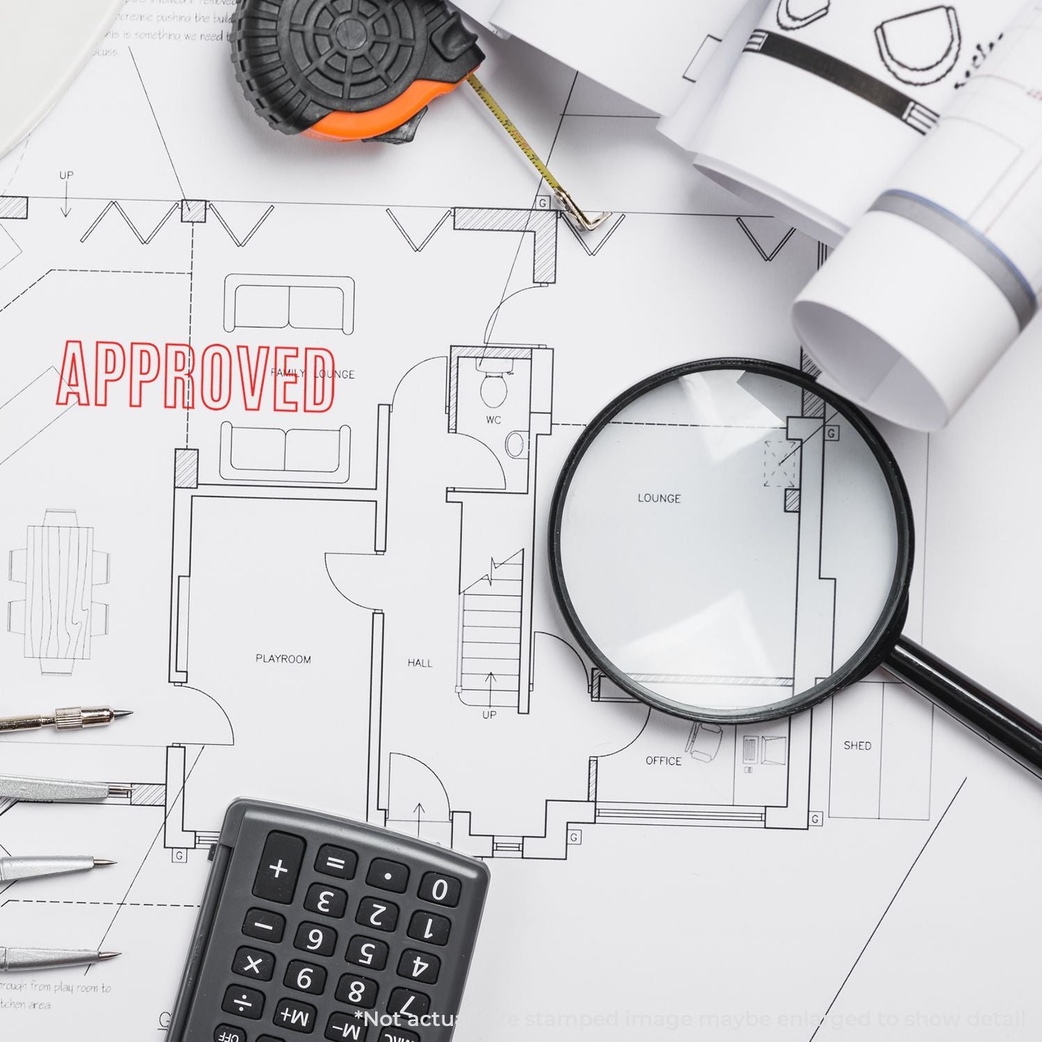 Approved architectural floor plan with tape measure, magnifying glass, calculator, and drafting tools for home renovation and construction planning