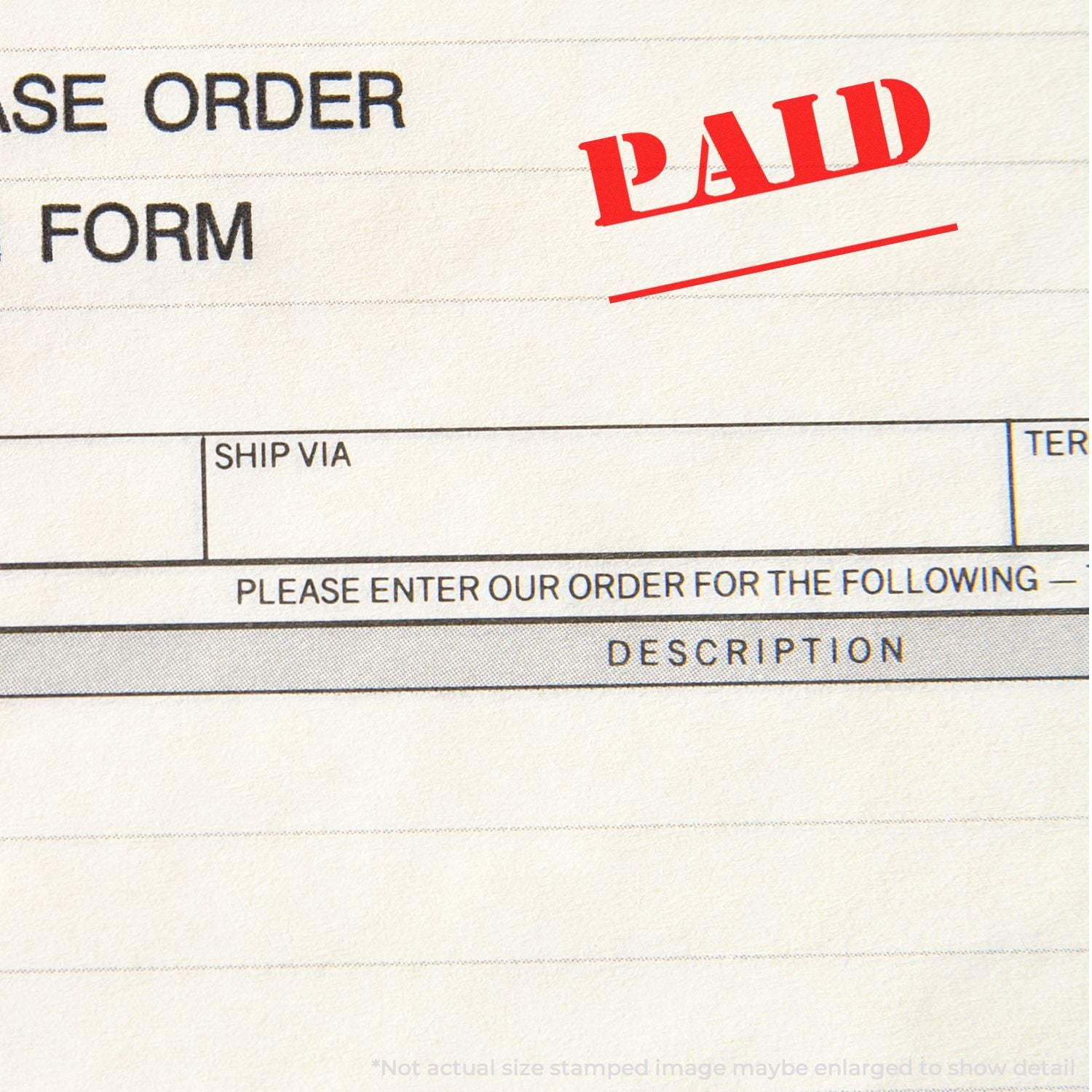 Paid stamp on purchase order form with ship via and description fields, business invoice document close-up.