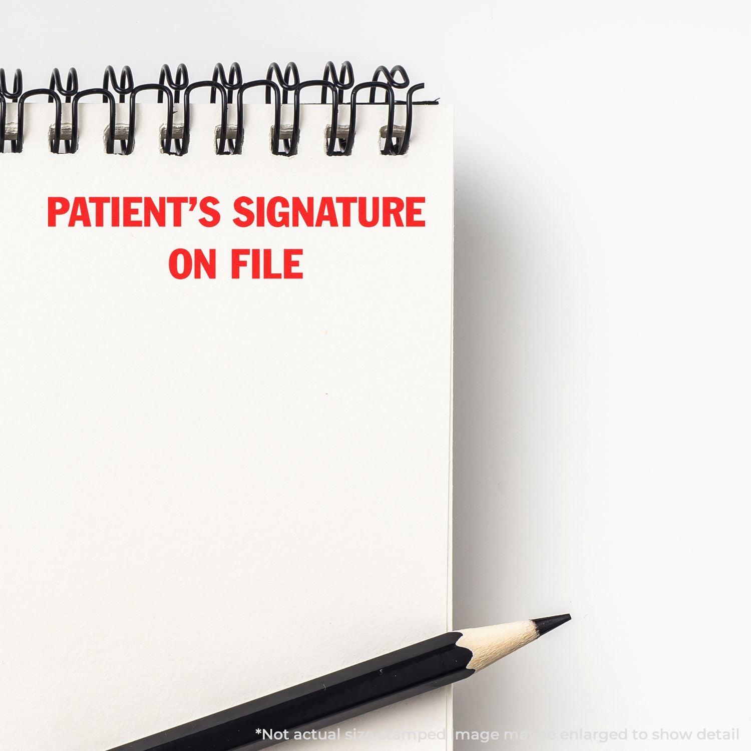Notebook page with Patients Signature on File text and pencil, representing medical consent form and patient records.