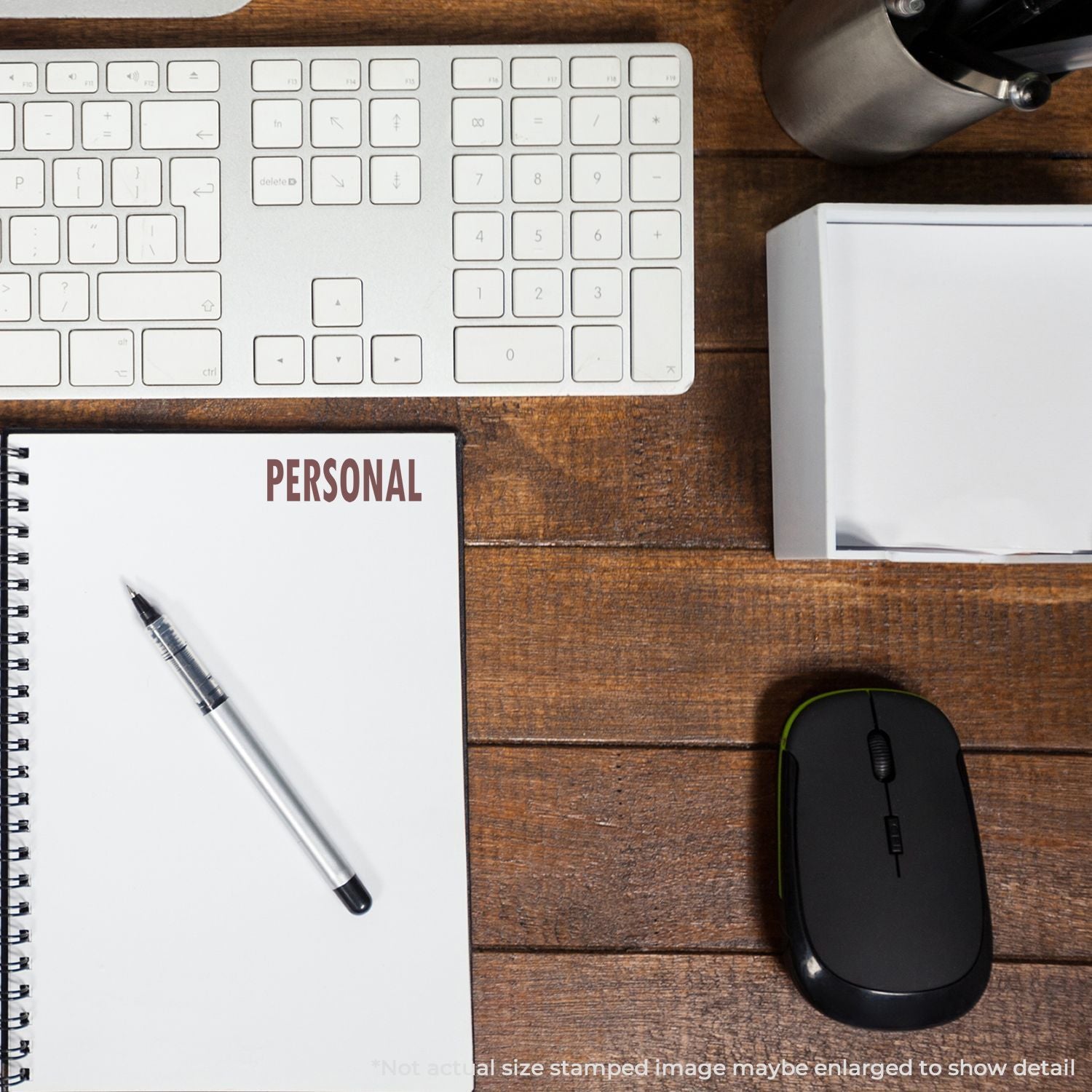 Top view home office setup with keyboard, mouse, and personal notebook labeled PERSONAL for planning and productivity