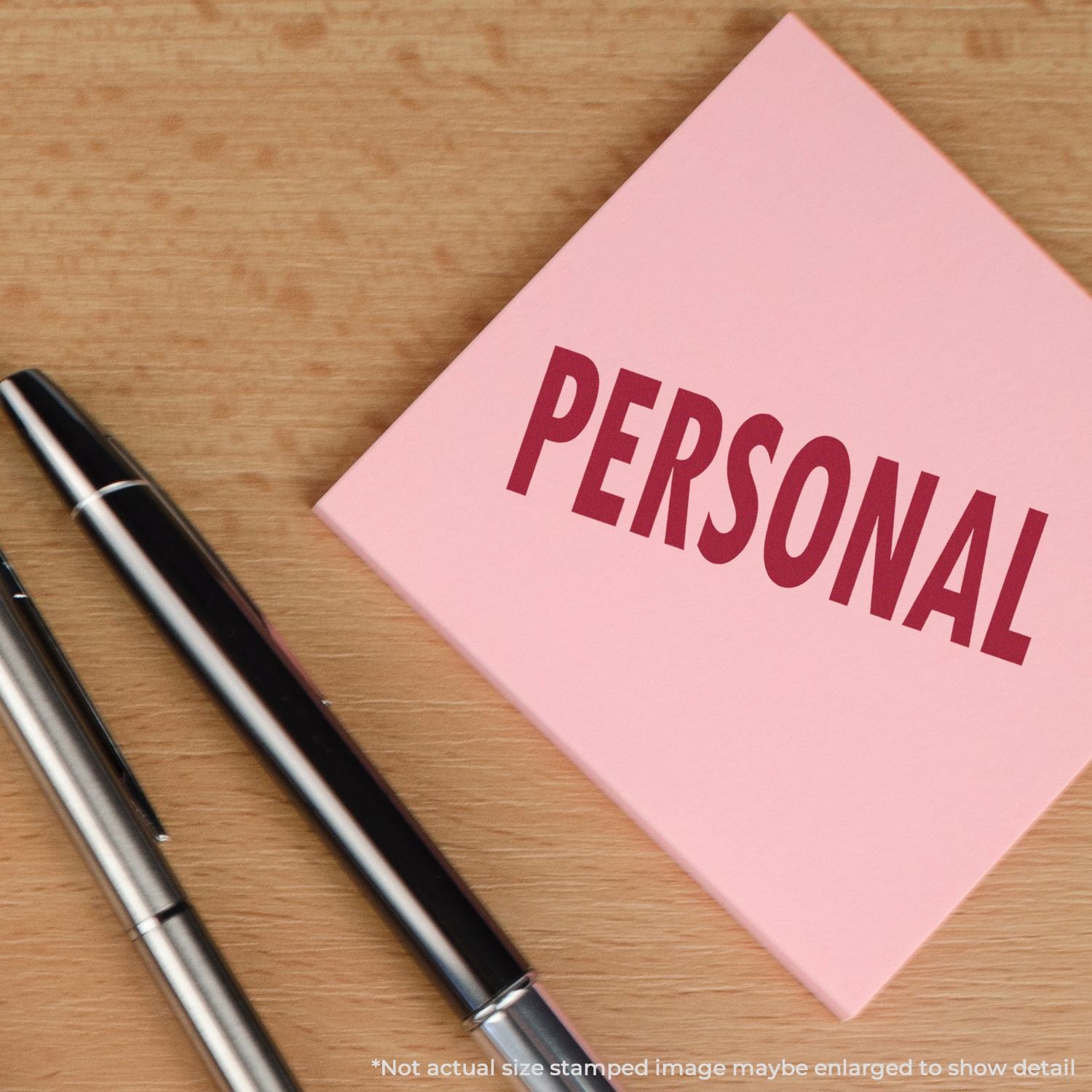 Pink PERSONAL journal notebook with two pens on a wooden desk, showing ideas for private note-taking.