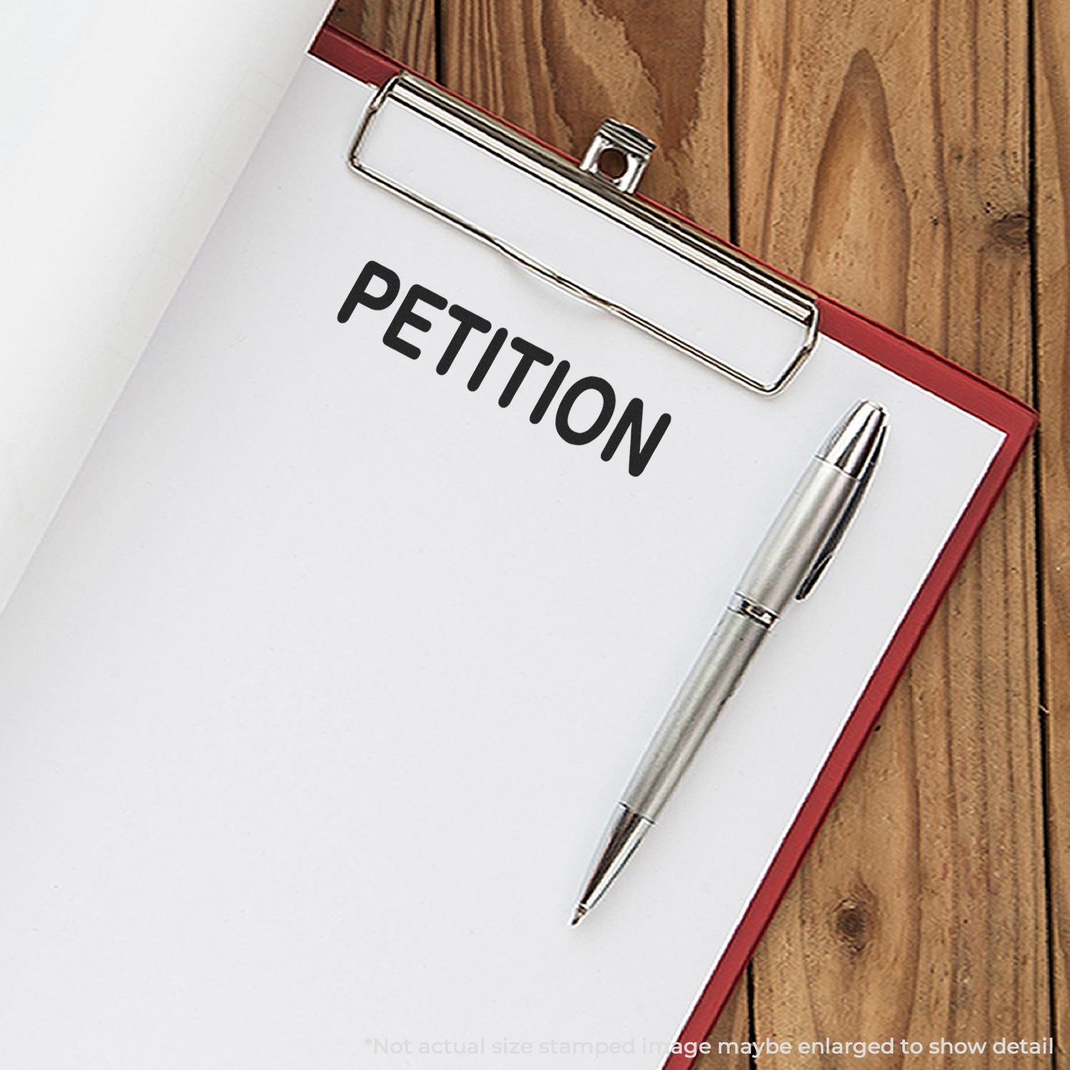 Clipboard with petition form and pen on a wooden desk.