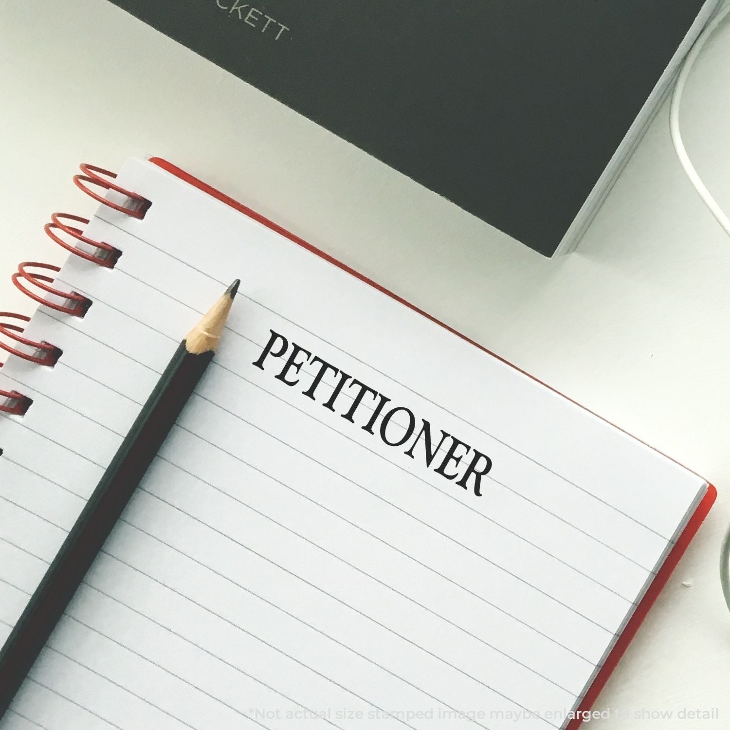 Petitioner legal notebook with pencil, symbolizing petition writing for court case and legal filings.