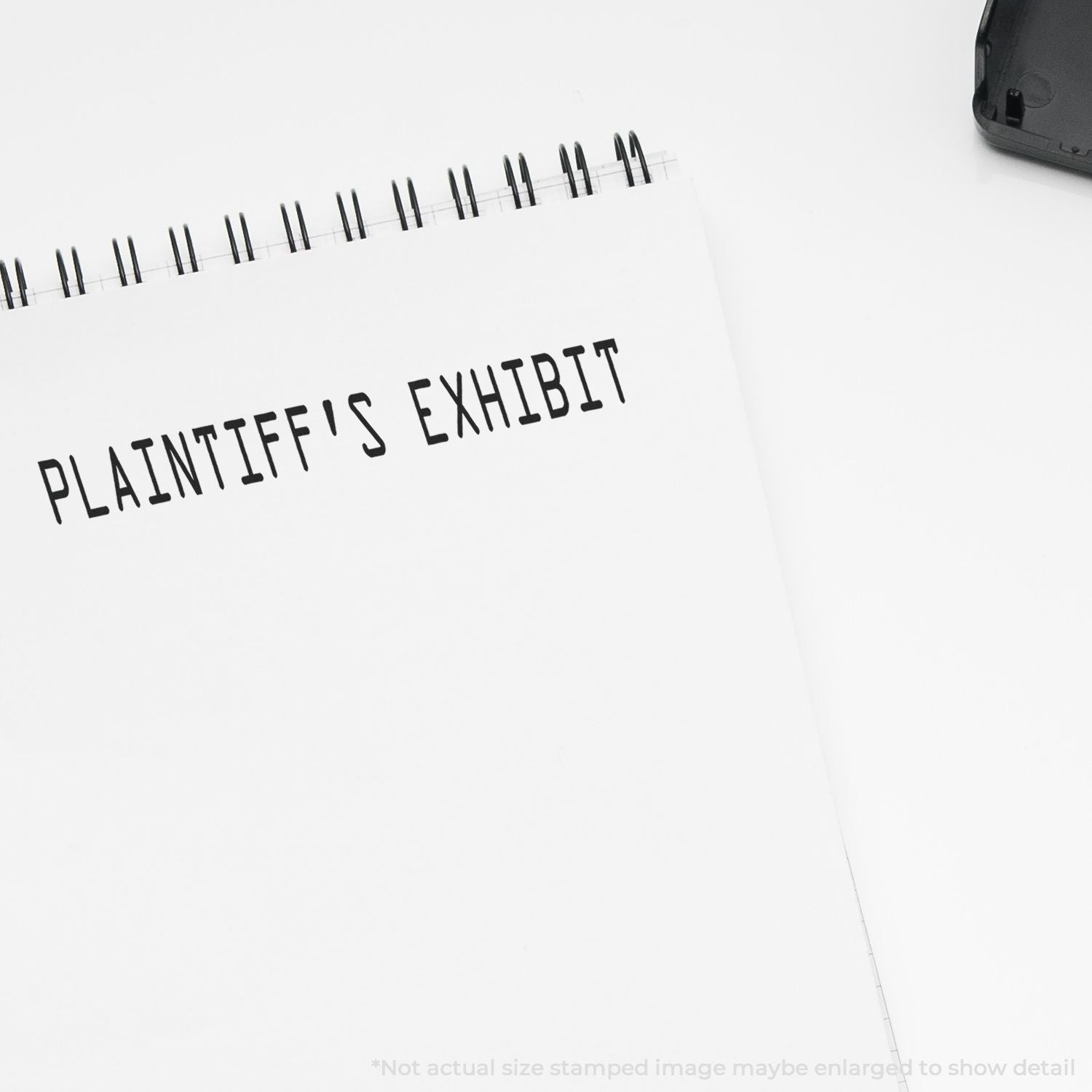 Plaintiffs Exhibit evidence label on a notebook, suggesting legal case documentation and court filing materials.