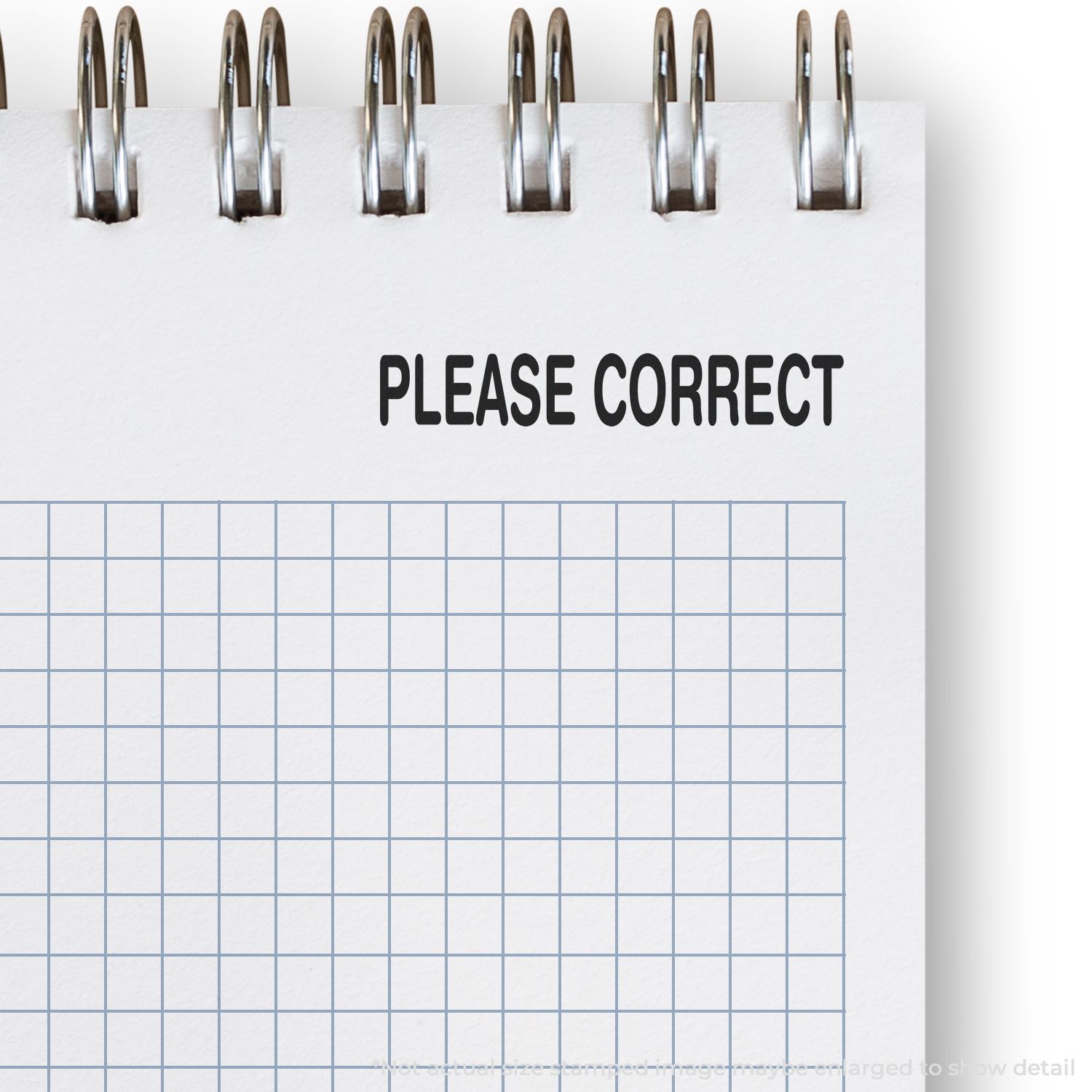 Blue grid worksheet with stapler clips and PLEASE CORRECT text, indicating proofreading and editing needed.