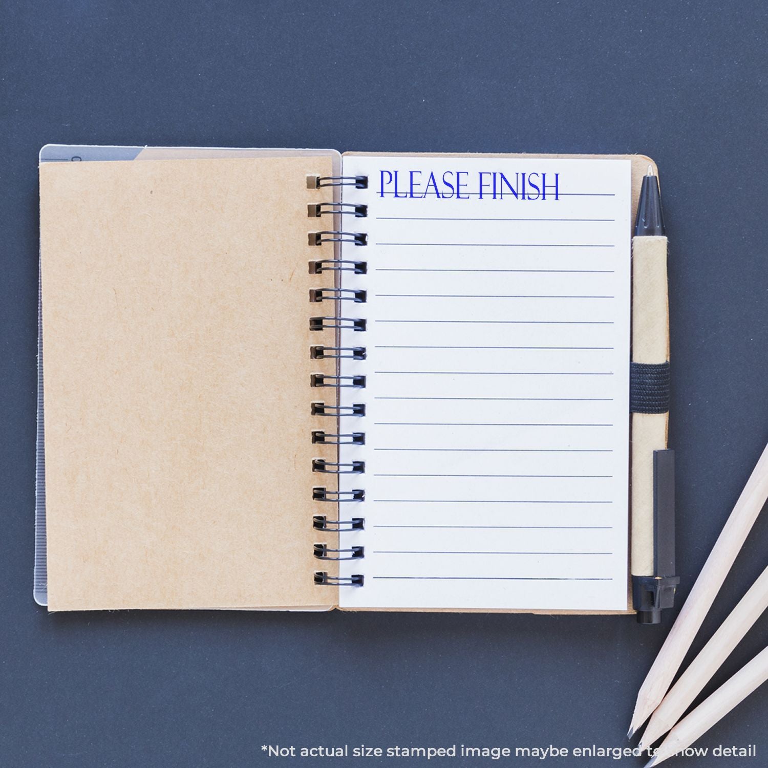 Open notebook with lined pages reading PLEASE FINISH, symbolizing writing tasks and productivity with a pencil on a desk.
