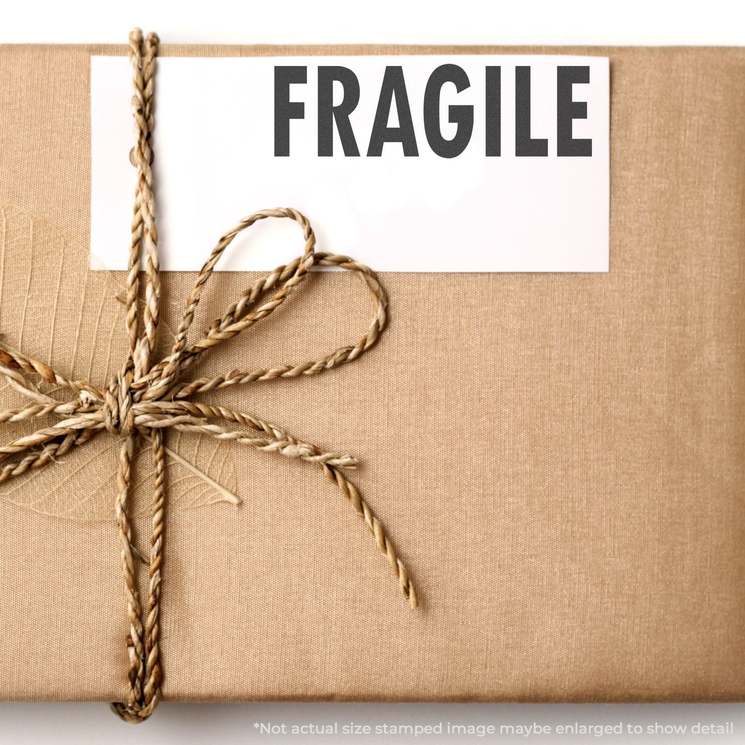 Fragile shipping label on a jute rope-wrapped package, warning carriers to handle contents with care during transit.