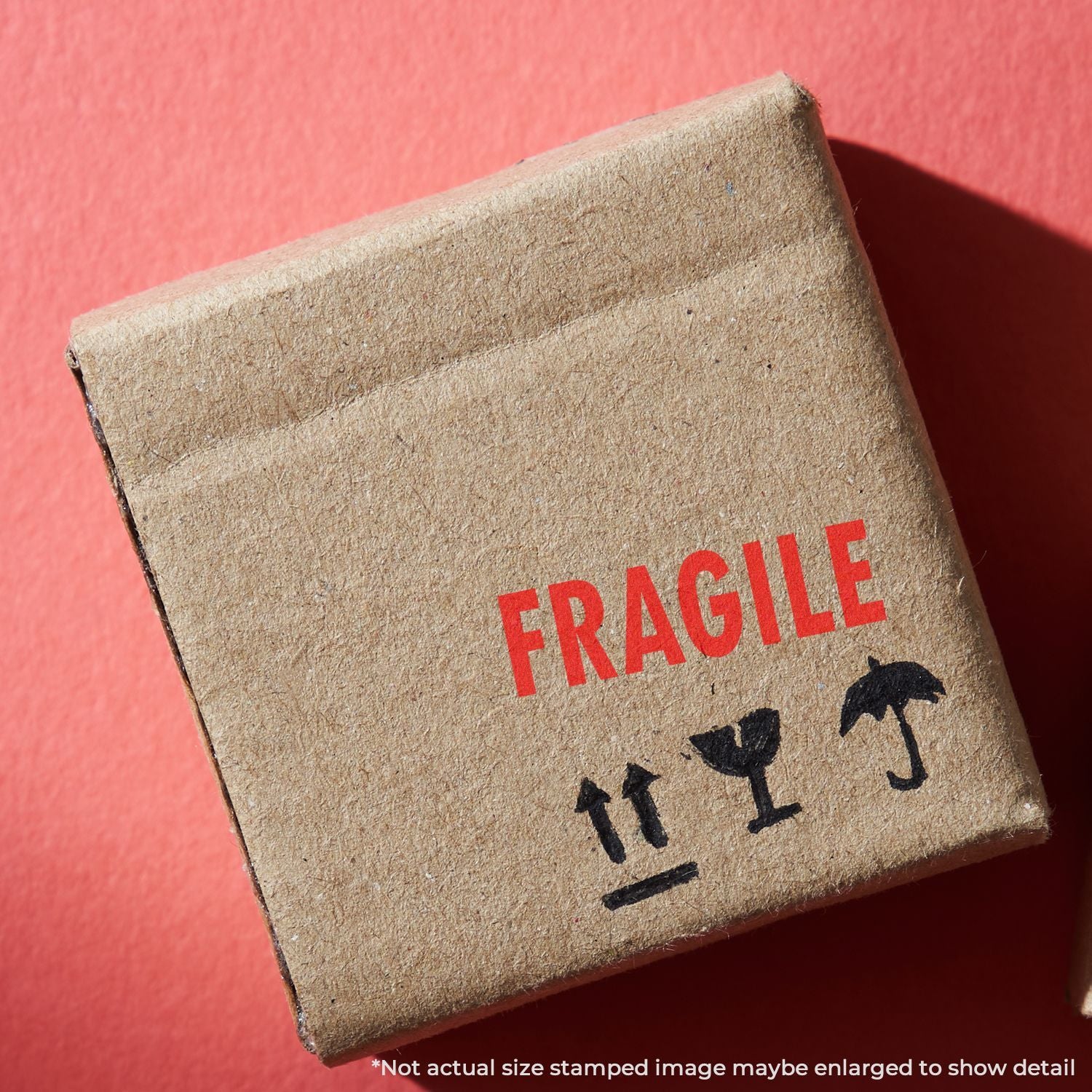 Close-up of a FRAGILE stamp on a shipping box, warning handlers to handle with care during transport.