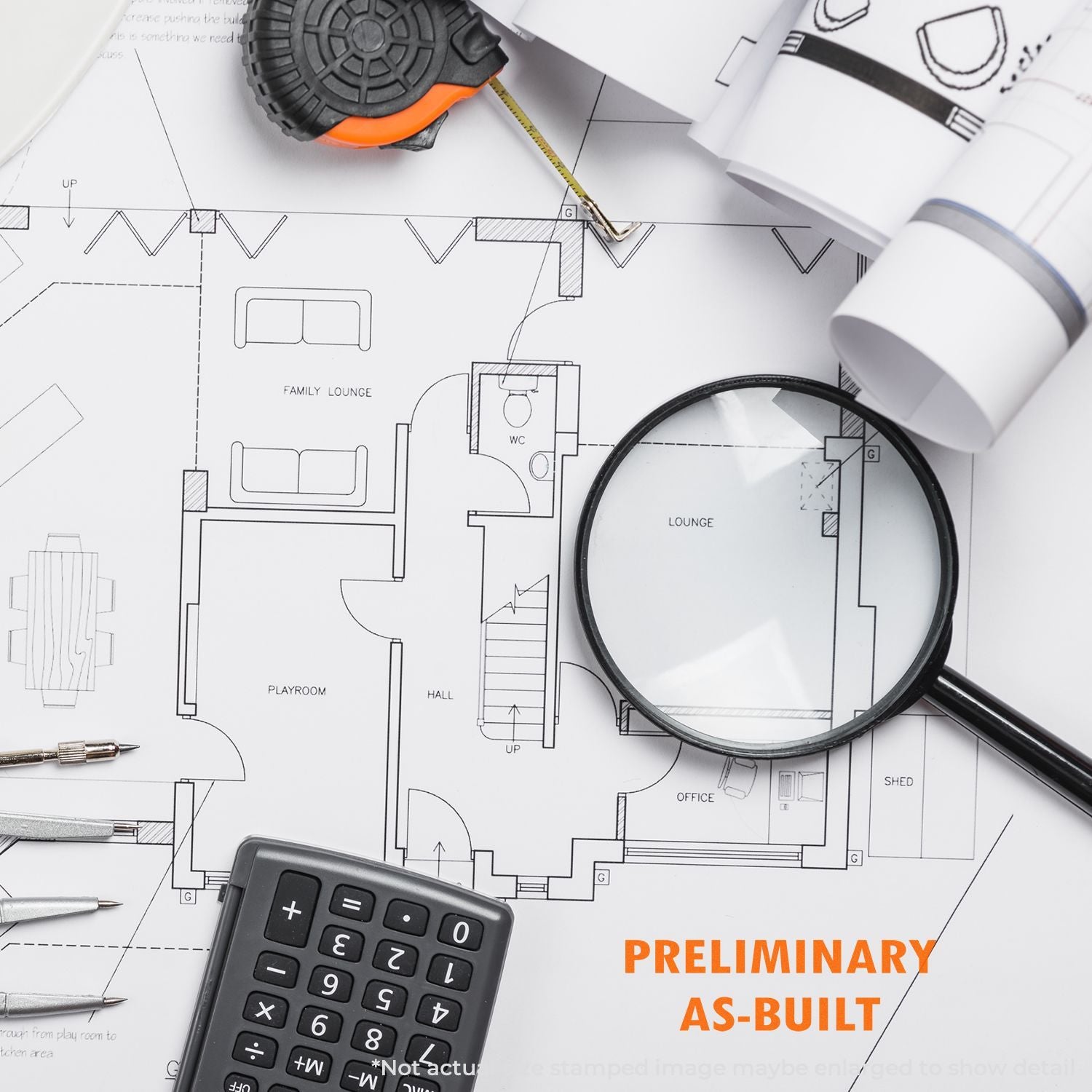 Architectural floor plan blueprint with magnifying glass, tape measure, calculator, and rolled drawings for home renovation and as-built planning.