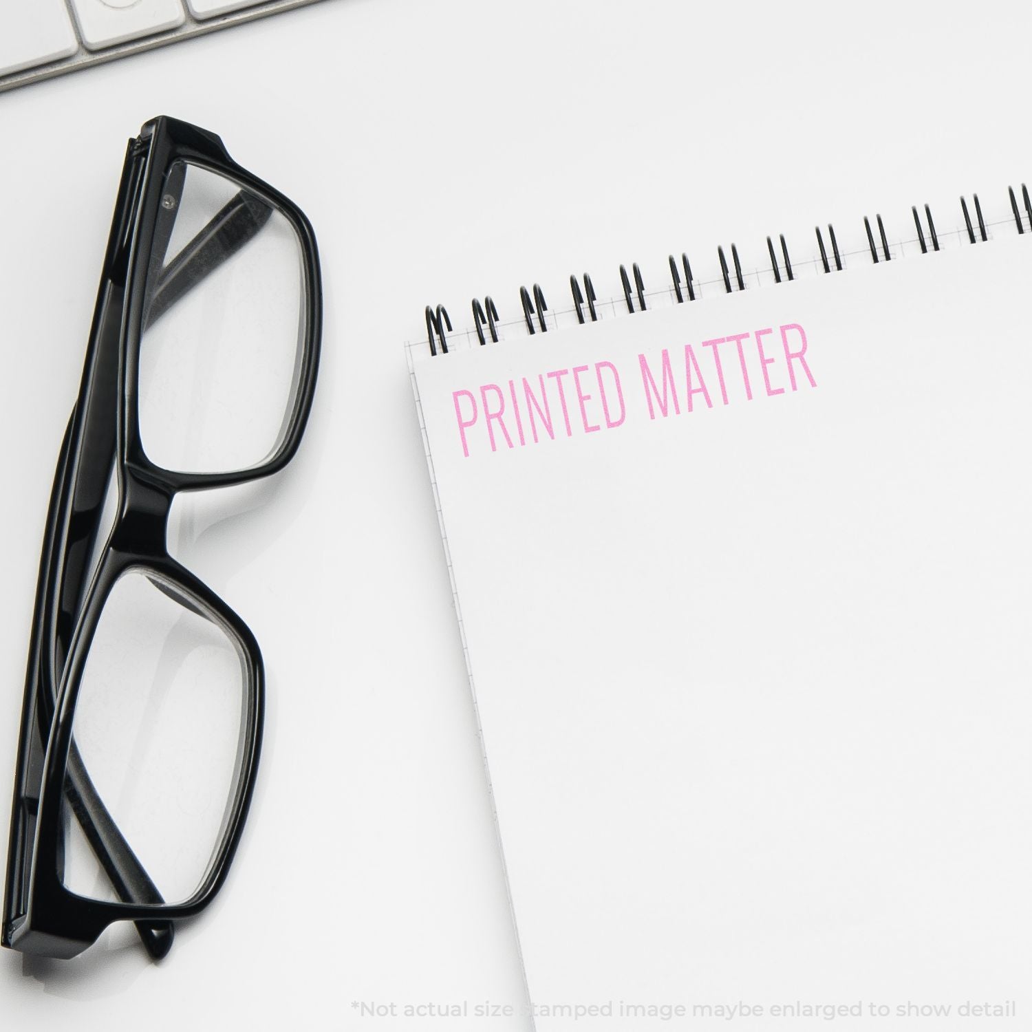 Eyeglasses beside a Printed Matter notebook, illustrating printed documents for publishing and marketing design.