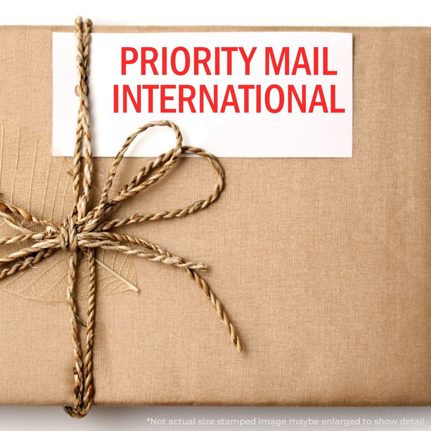 Priority Mail International shipping package wrapped in twine with a red postal label on brown kraft paper.