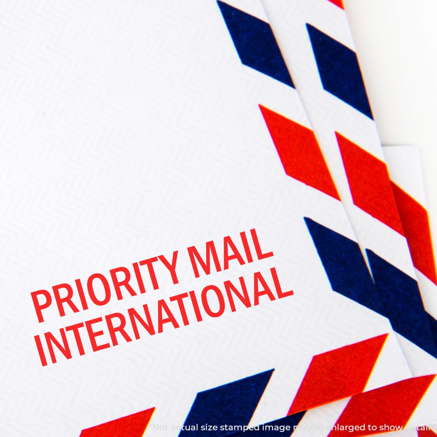 Priority Mail International envelope with red and blue airmail border design close-up.