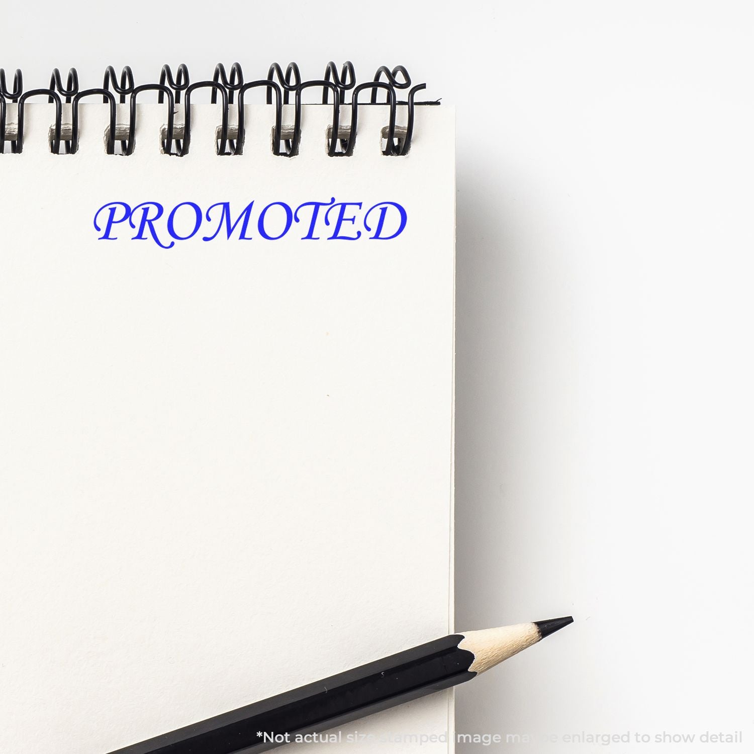 Promoted concept page with pencil and binder clips, highlighting the marketing word PROMOTED for branding and promotion.