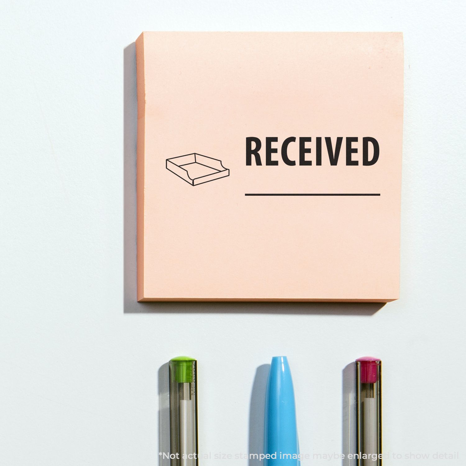 Pastel peach RECEIVED stamp box with tray icon on a white background, with colorful pens below.