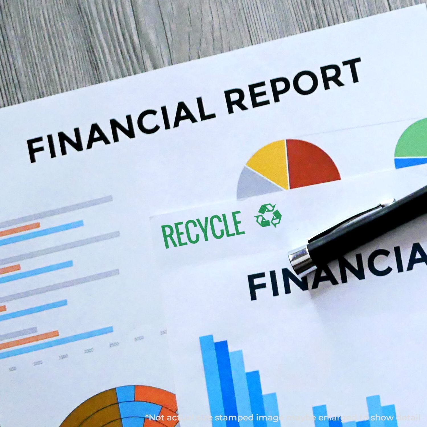 Financial report with colorful charts, recycle icon, and pen on desk, business sustainability and accounting concept.