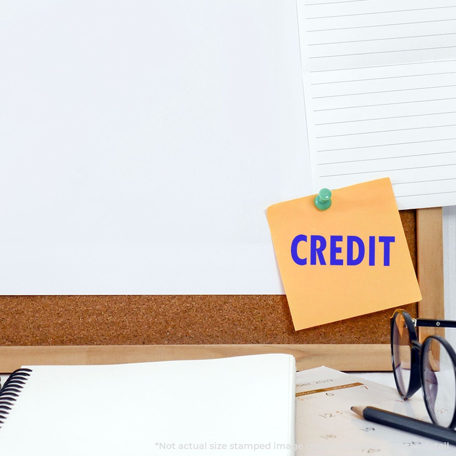 Orange note pinned on cork board with CREDIT lettering, symbolizing business credit and financial credit management.