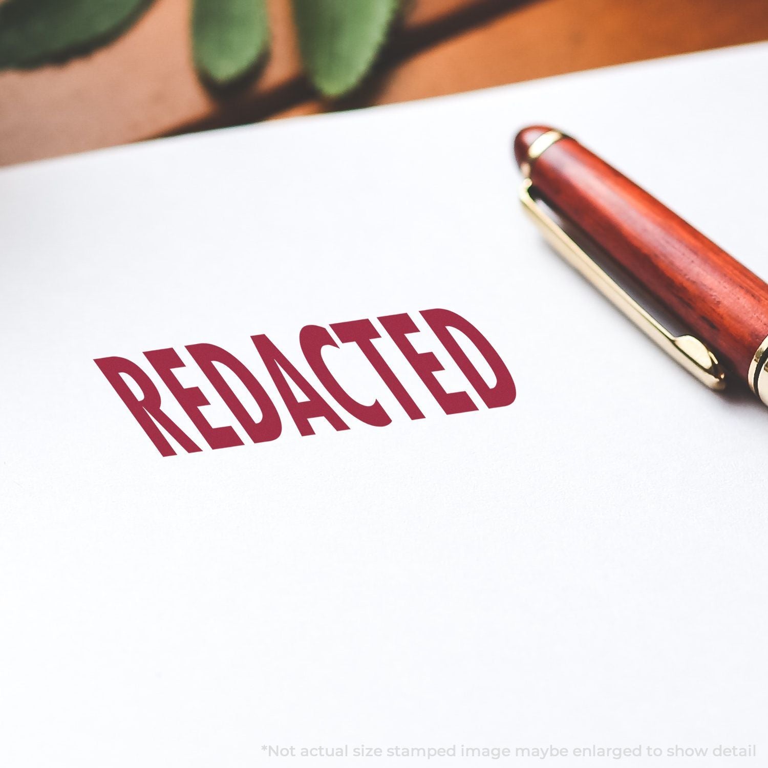 Redacted document with red stamp and pen on white paper