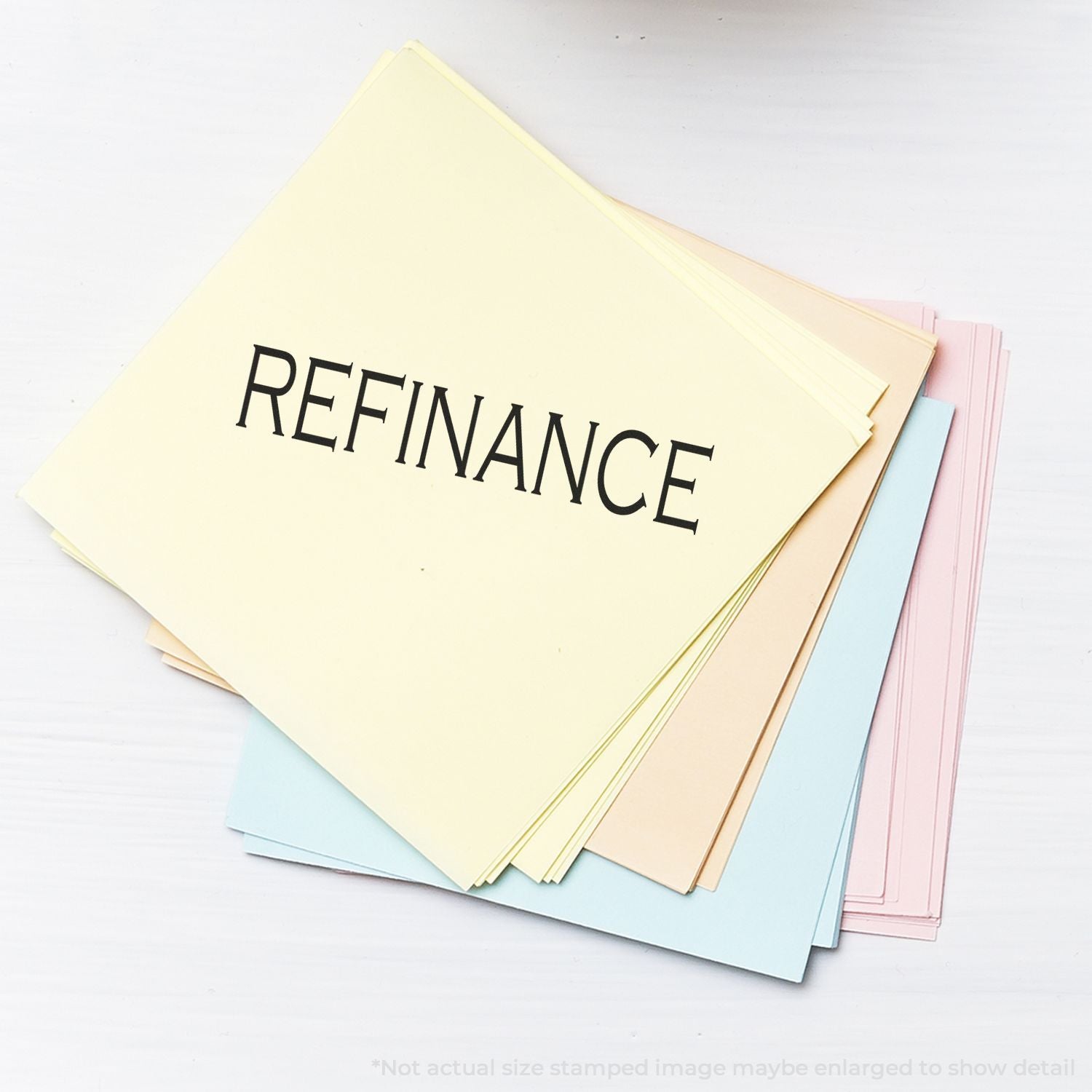 Stack of colorful folders labeled REFINANCE, representing loan refinancing options for homebuyers and financial planning.