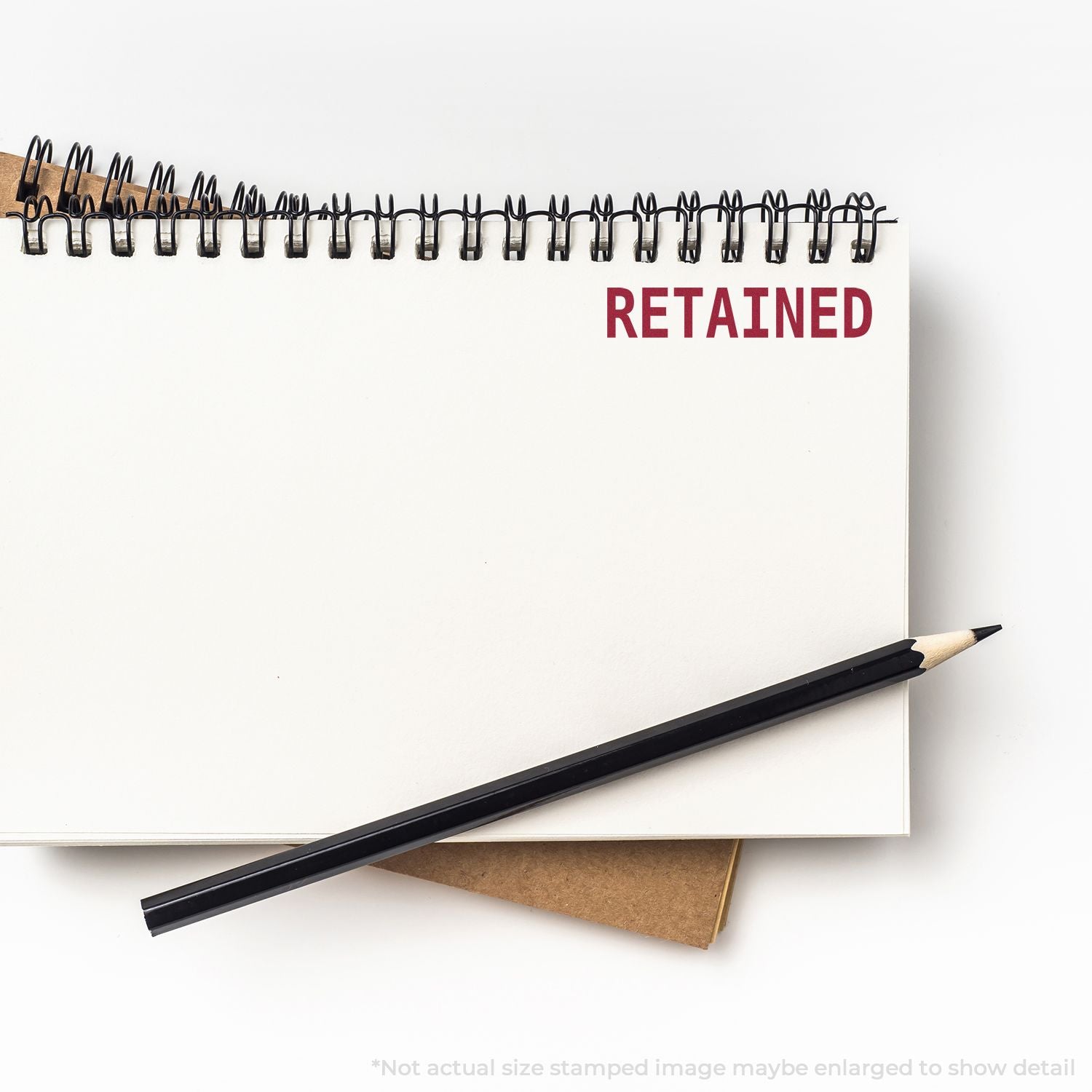Retained notebook with pencil, labeled for document retention and note-taking on a clean desk background.