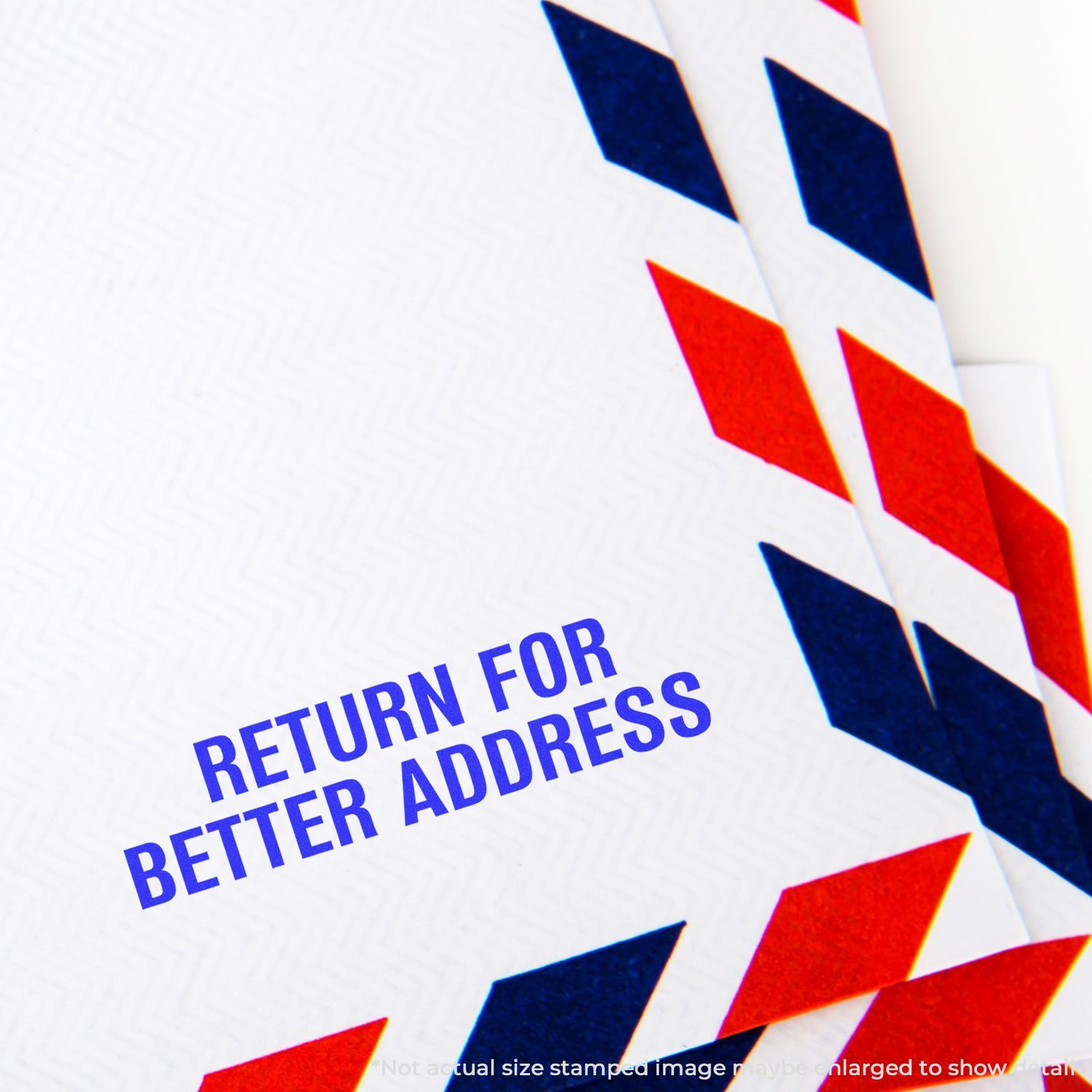 Close-up of a red, white, and blue airmail envelope with Return for Better Address printed on it.