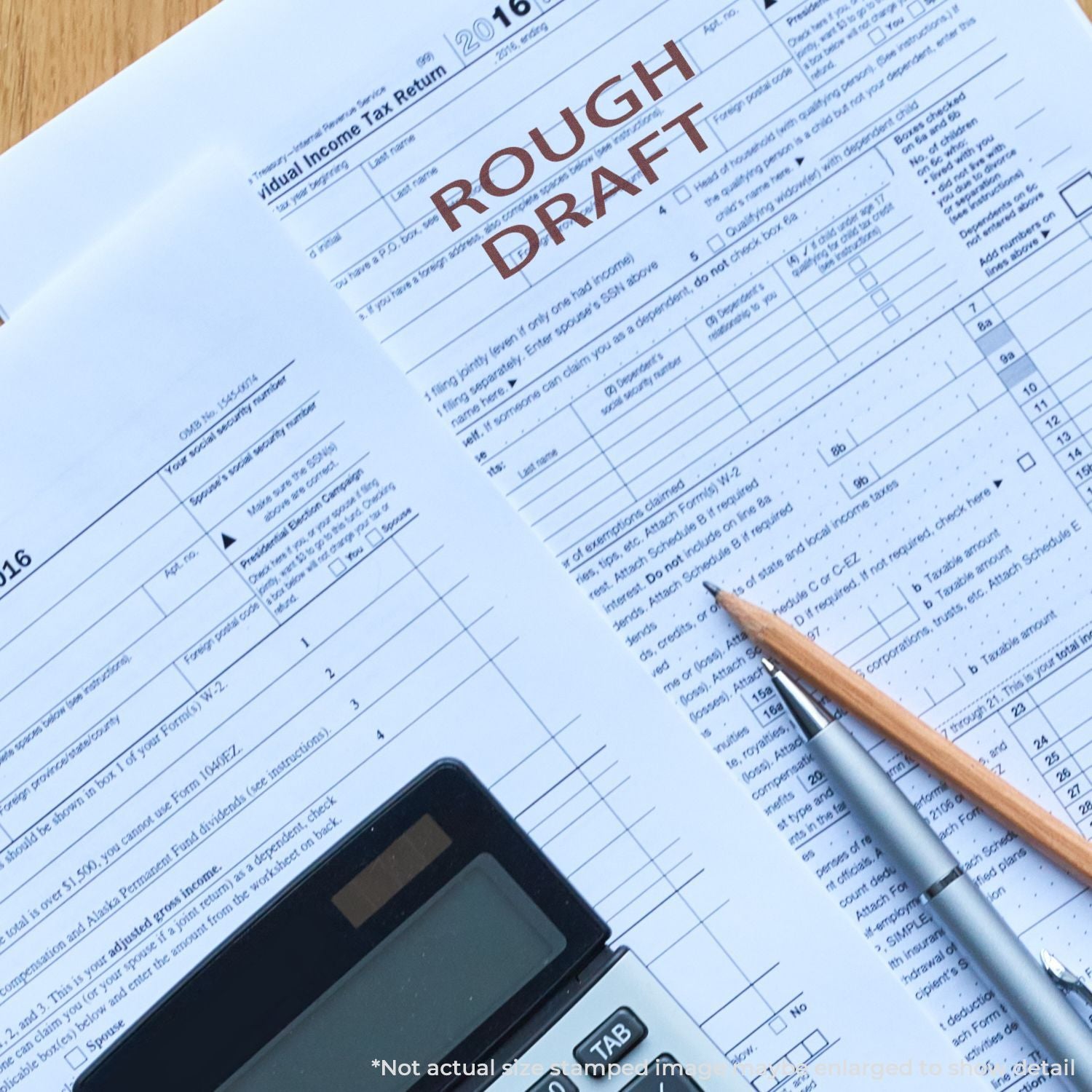 Rough draft of 2016 U.S. individual income tax return form with calculator, pen, and pencil on desk.