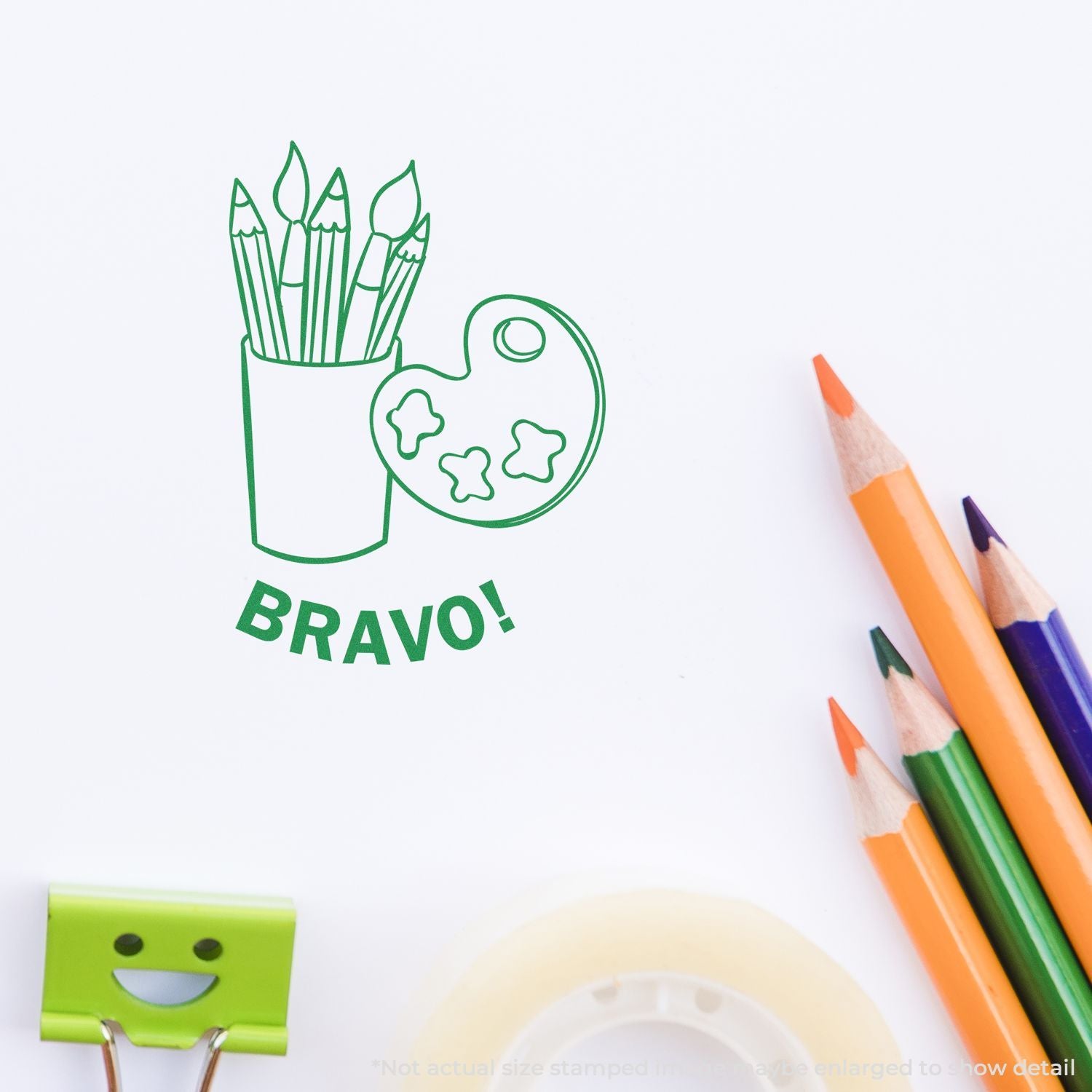 Green BRAVO! stamp with pencils and paint palette, art supplies on white background.