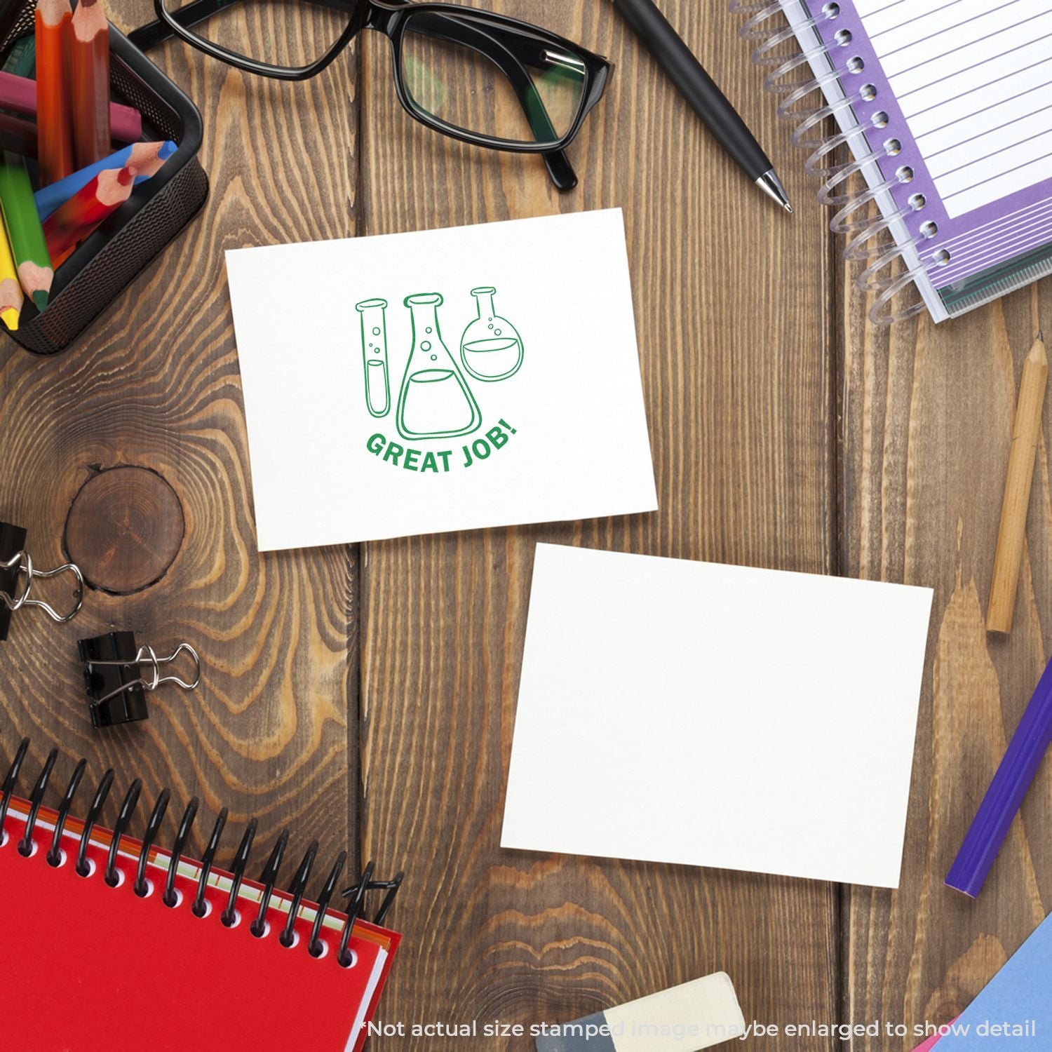 Science-themed Great Job! sticker on wooden desk with school supplies and notebooks
