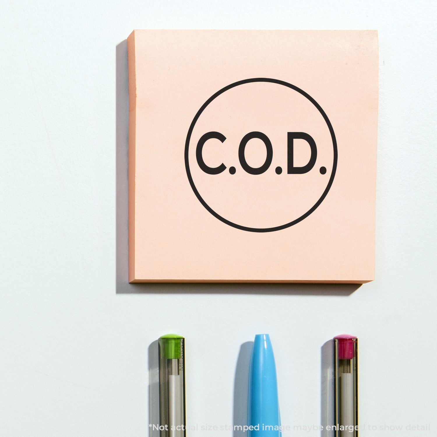 C.O.D. logo wall art on a pastel square panel with colorful pens on a white background.