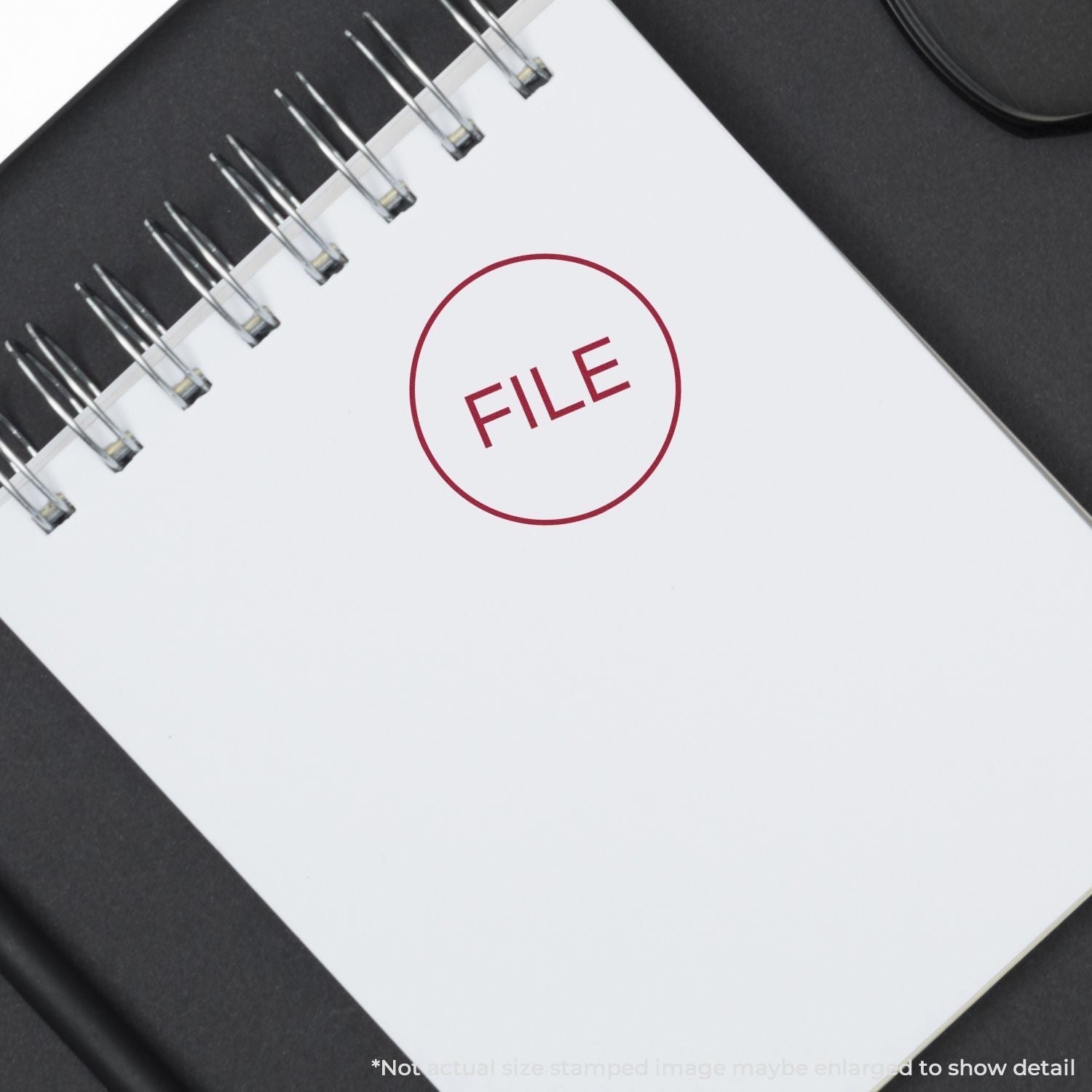 Spiral notebook with FILE stamp on white page, office paperwork and document management concept