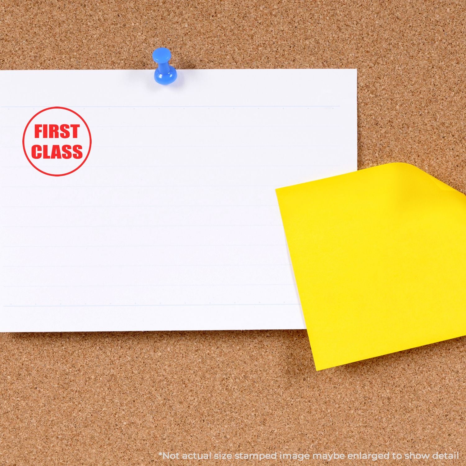 First class stamp on blank note pinned to cork bulletin board with yellow sticky note.