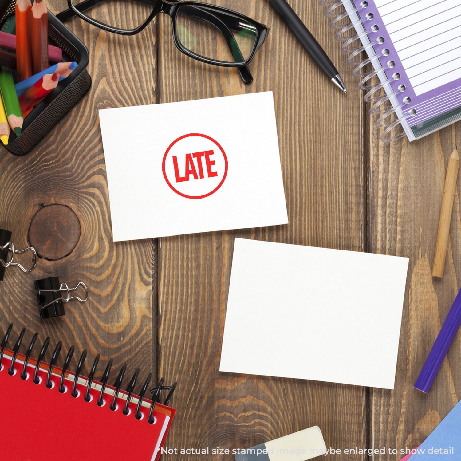 Late stamp on blank note paper surrounded by office supplies on a wooden desk, concept of deadline and work delay.