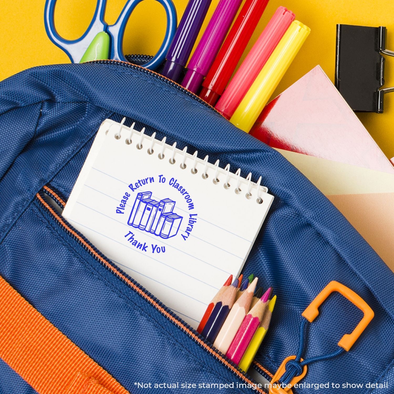 Colorful school supplies in a blue backpack, including notebook, pencils, markers, scissors, and a classroom library return note.