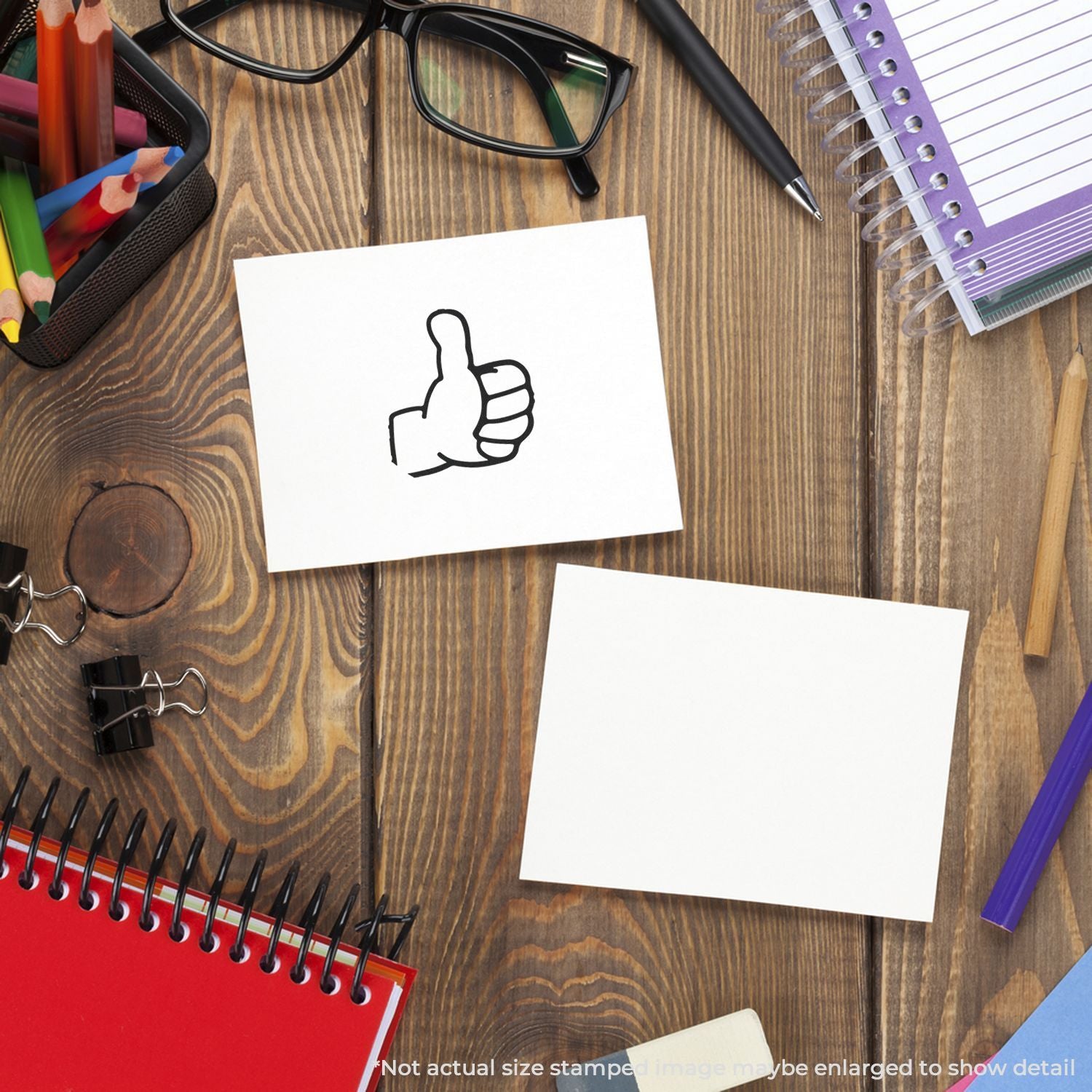 Creative office desk with stationery, notebooks, glasses, and thumbs up icon on white sticky note
