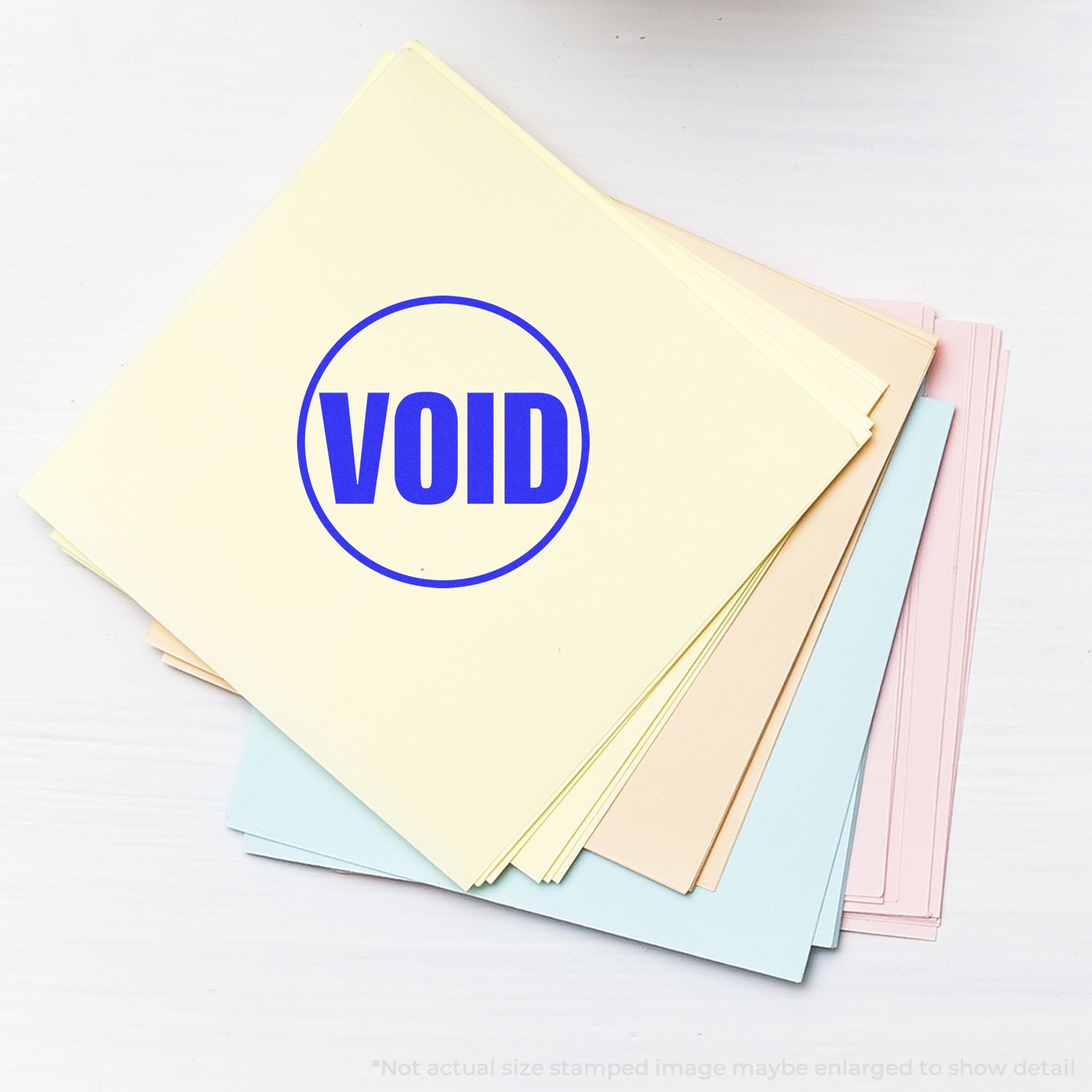 Stack of pastel paper sheets with blue VOID stamp on white background, voided business document concept
