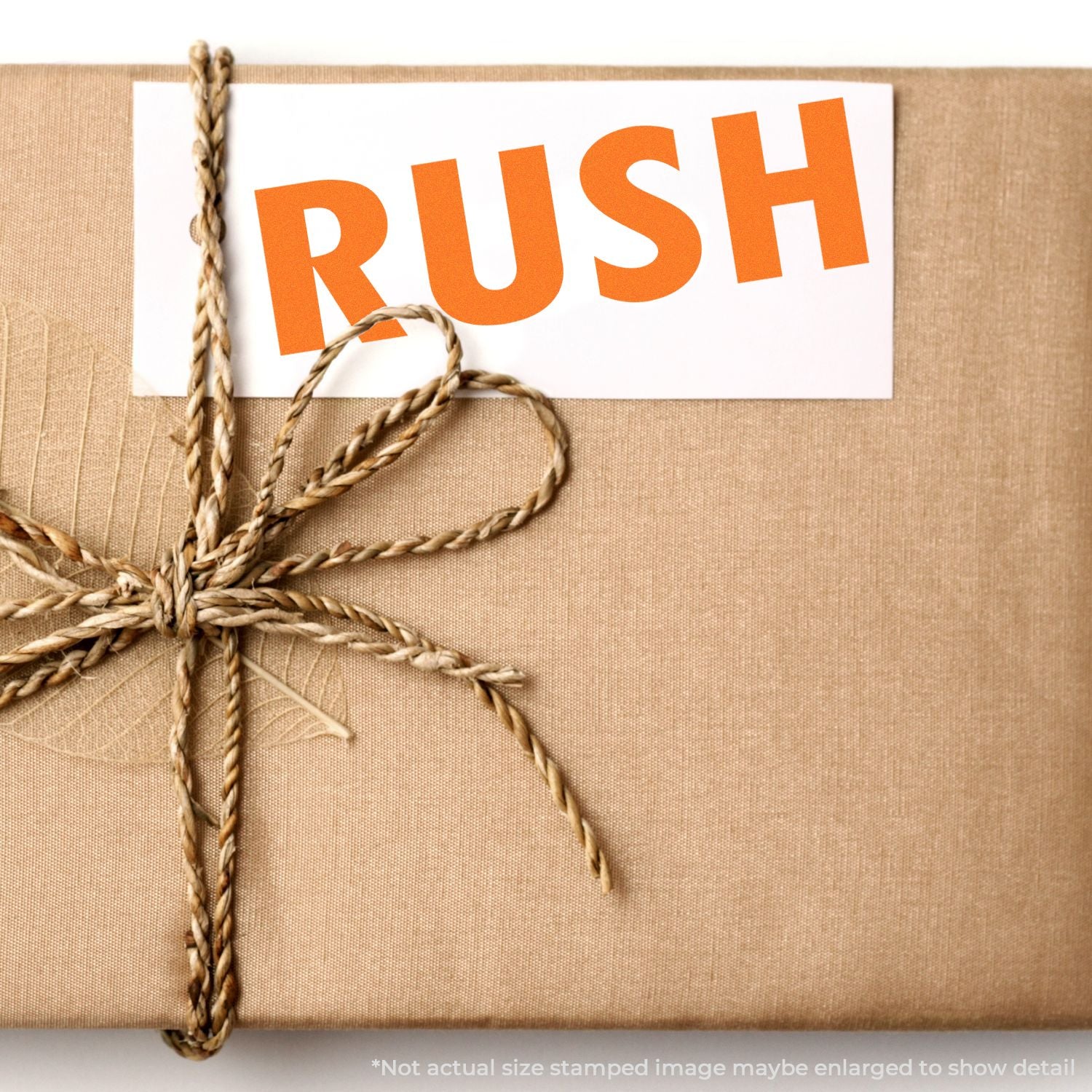 Brown wrapped gift with twine and orange RUSH label for urgent shipping.