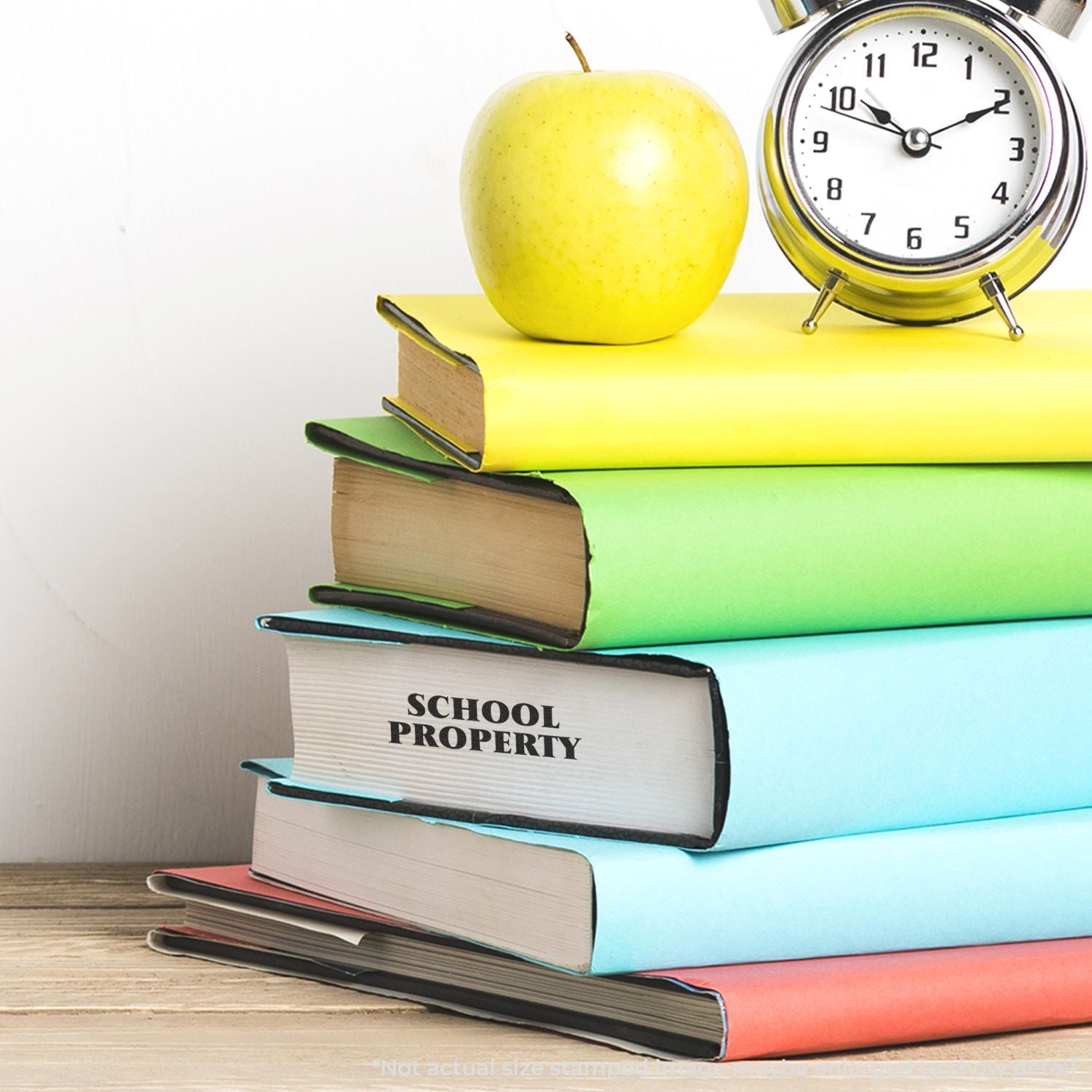 Alarm clock and apple beside stacked books labeled School Property, symbolizing time management for learning and school readiness.
