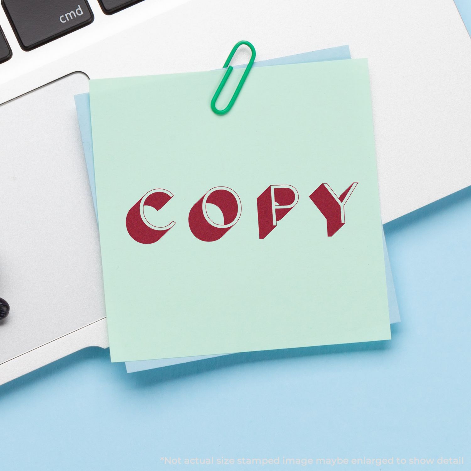 Mint green memo paper pinned with a green paperclip, showing a red COPY stamp to represent document copying and office copy services.