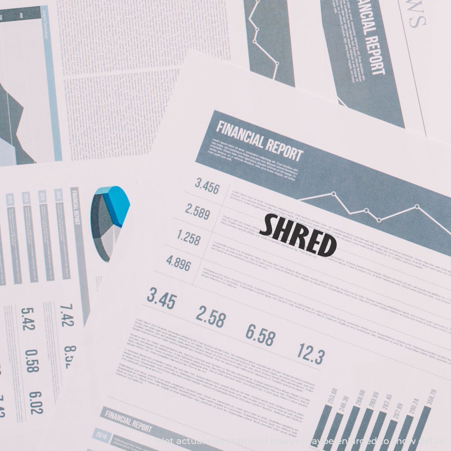 Shredded financial report pages with charts, graphs, and business analytics data on a desk.