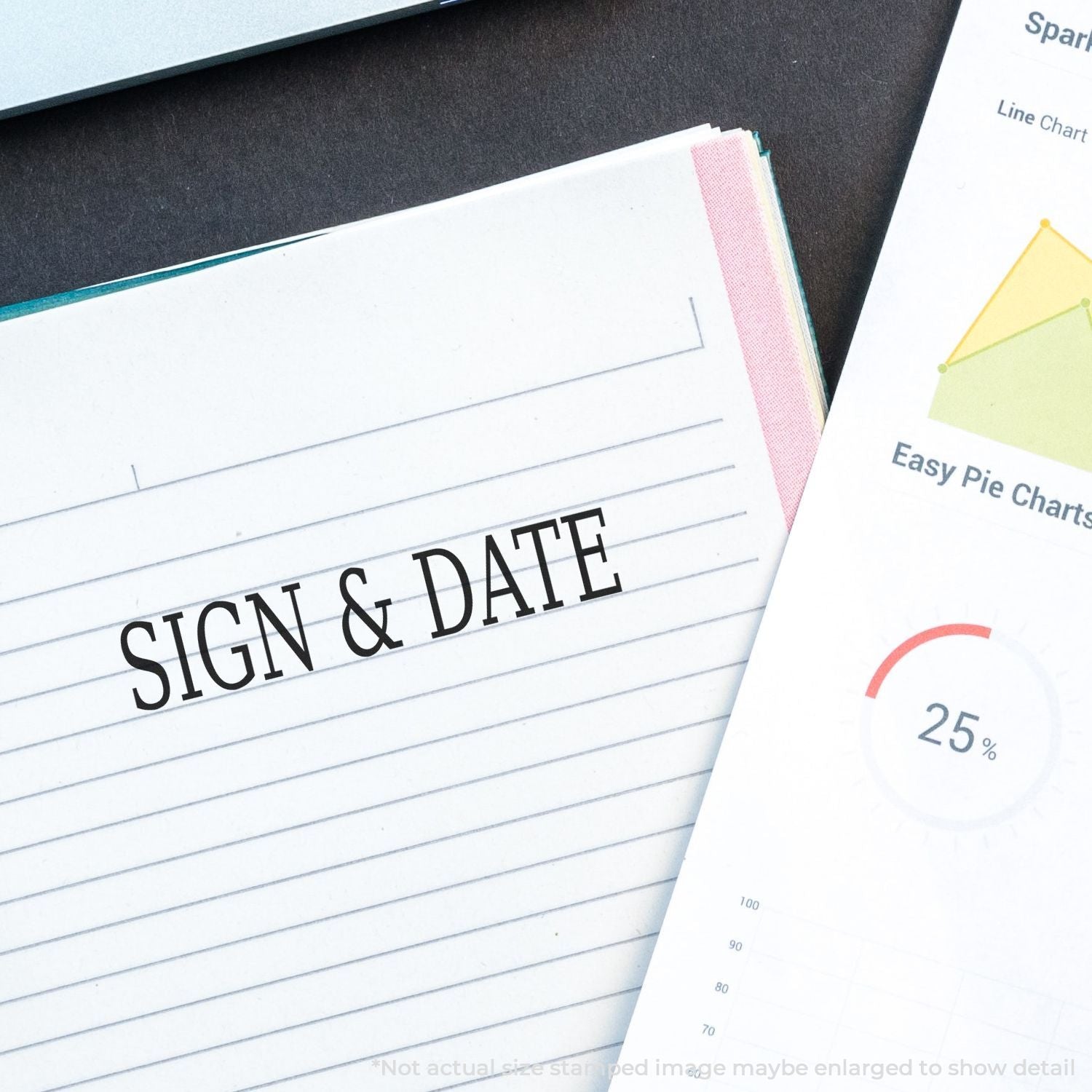 Close-up of a sign and date planner notebook with chart templates and business planning pages on a desk.