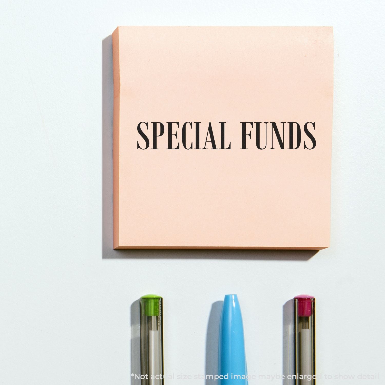Special Funds stamped pink packaging with colorful pens on a white background, modern stationery product display.