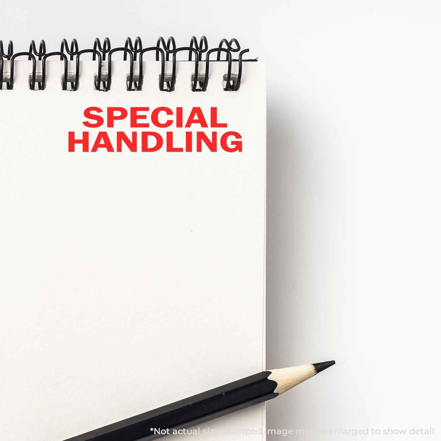Special handling warning sign on clipboard with binder clips and pencil, indicating shipping or packaging requires extra care.