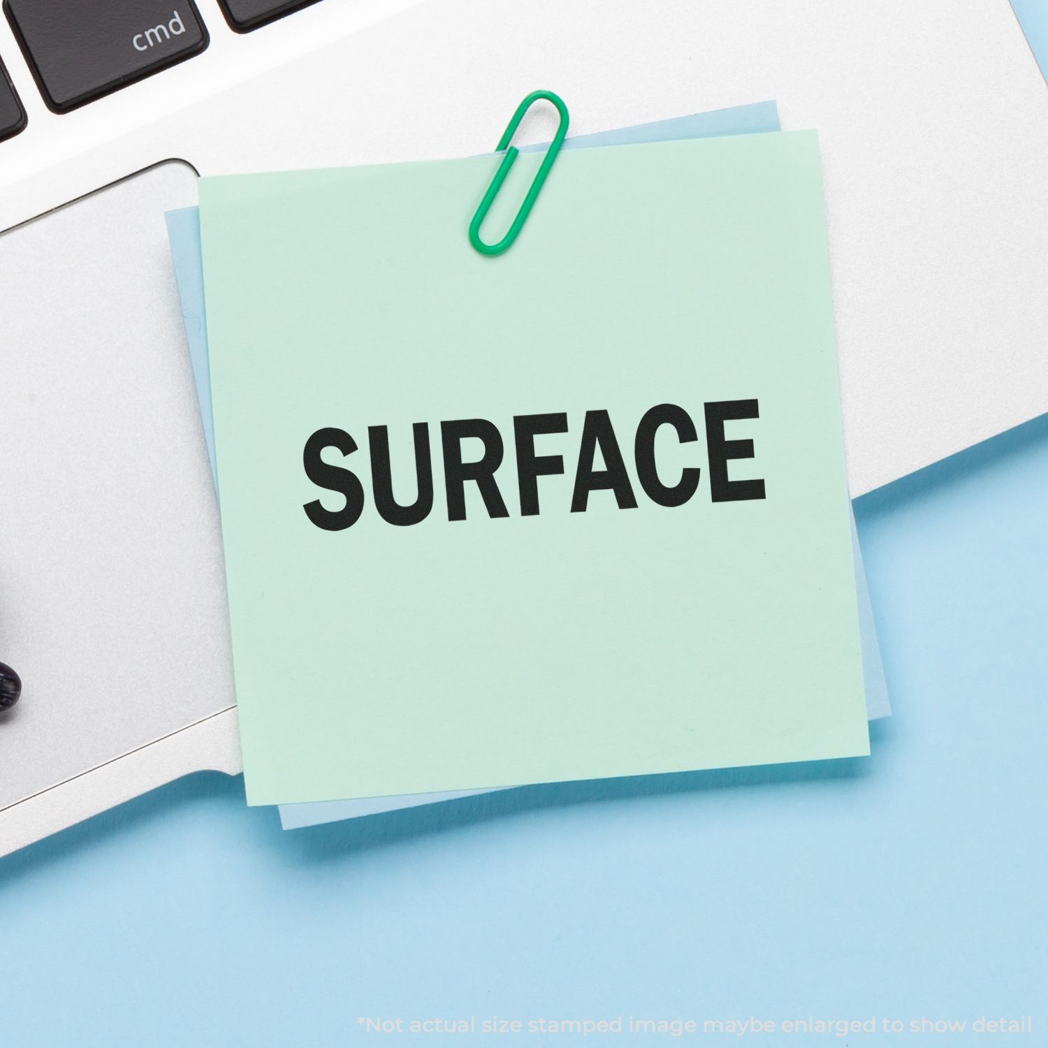 Note card labeled SURFACE with paperclip on office desk, representing surface finish and surface testing.